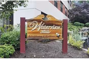 Exterior sign for Waterview Hills Rehabilitation and Nursing Center amid greenery.