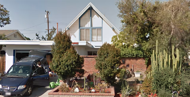 Front view of Fourth Street Home, a senior living residence, with a van parked outside.