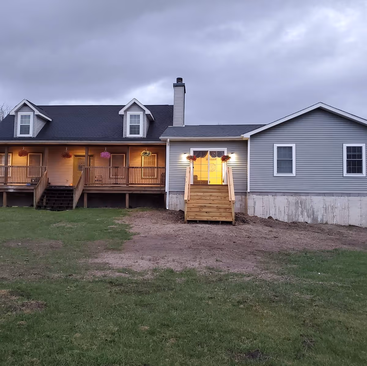 Exterior of A and R Premiere Care facility with a wooden porch and lit entrance.
