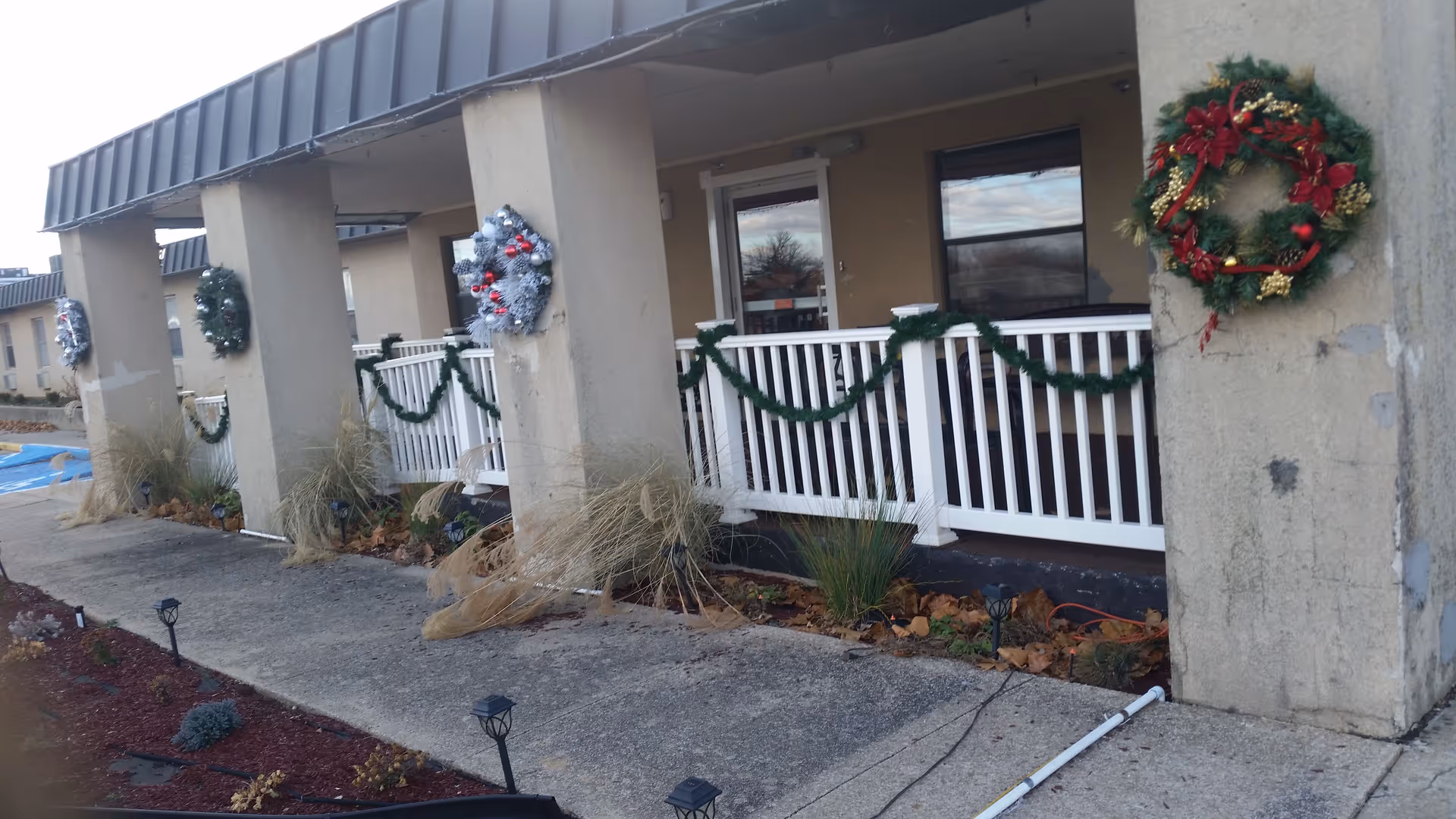 Exterior view of Hays House senior living facility entrance decorated with garlands and wreaths