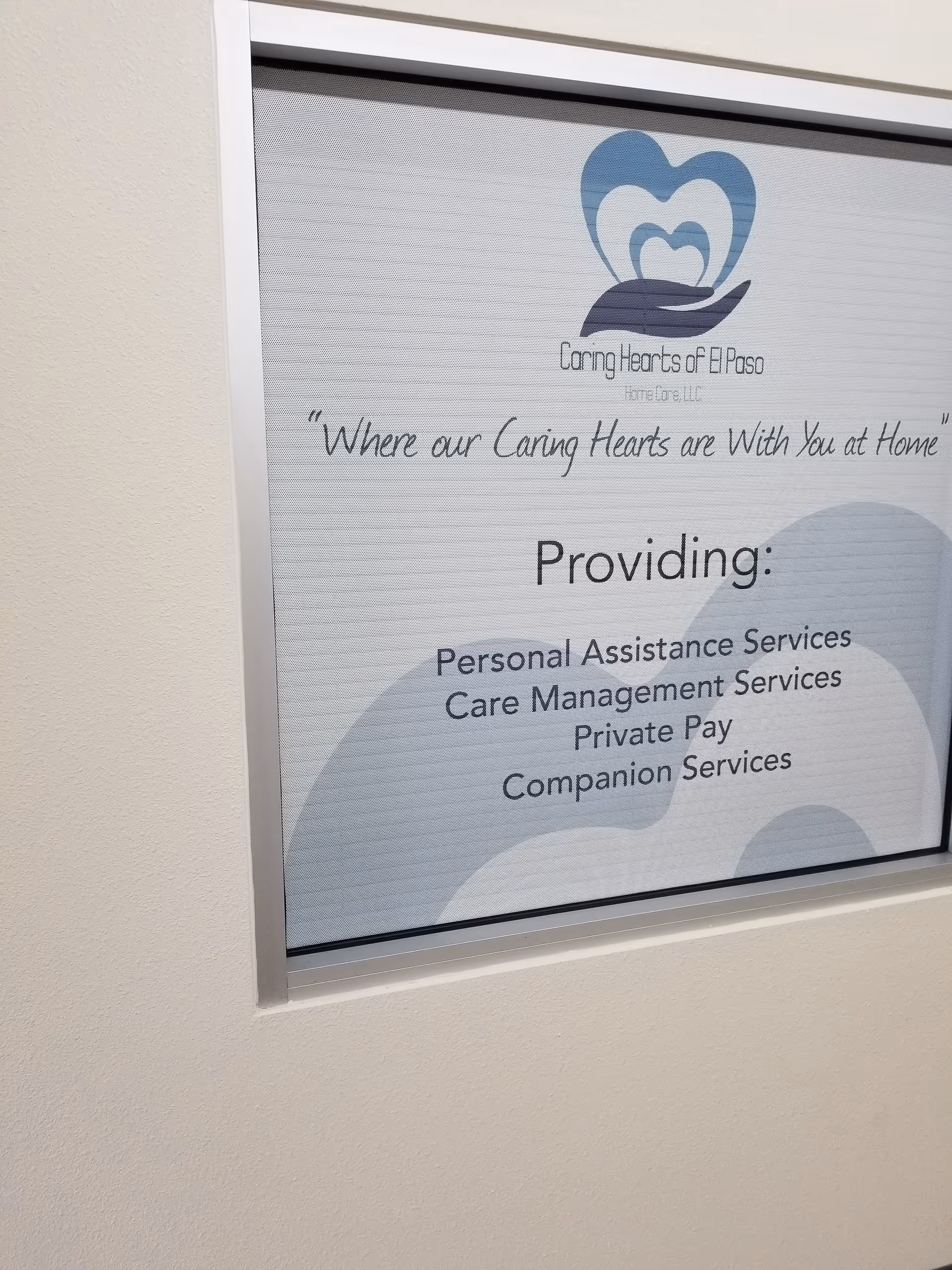 Interior wall sign showing Caring Hearts of El Paso logo and services