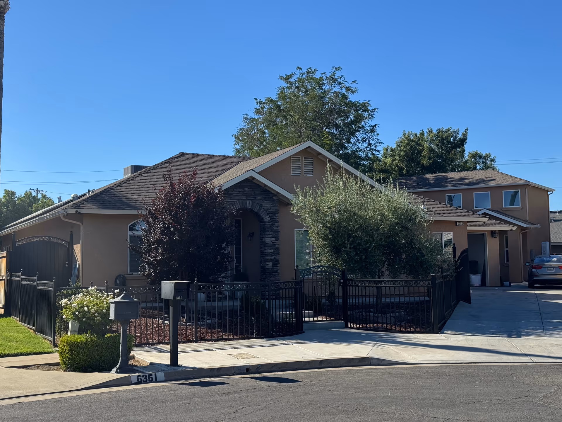 Front exterior of Ryan Lovely Assisted Living, a single-story home with a fence and driveway.