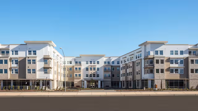 Exterior view of River's Edge Assisted Living, a multi-story senior living facility.