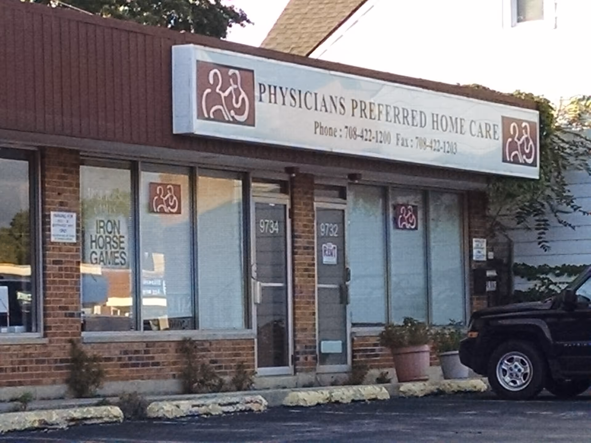 Brick storefront with large sign reading Physicians Preferred Home Care and glass windows.