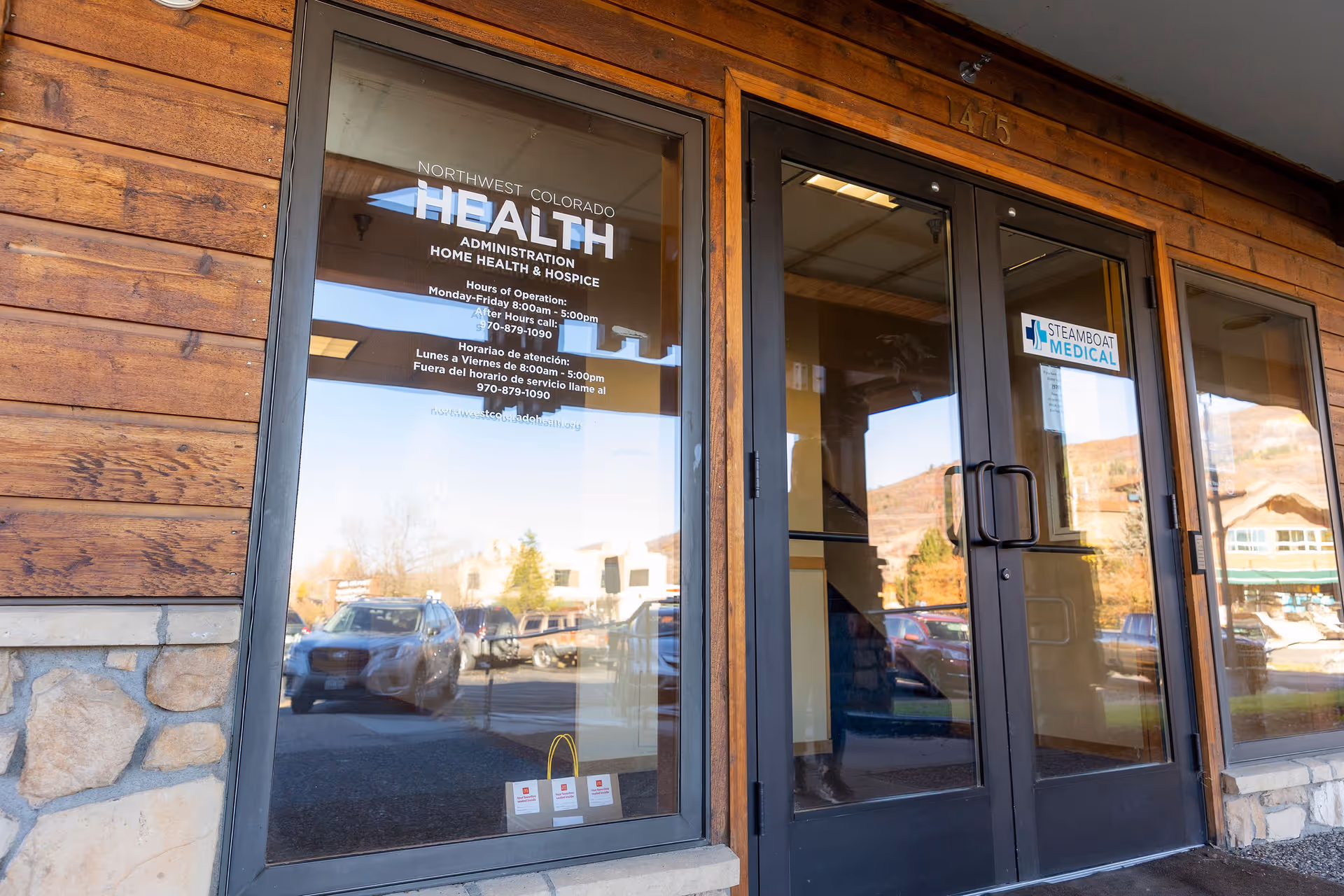 Exterior front entrance of Northwest Colorado Health building with wood siding and glass doors.