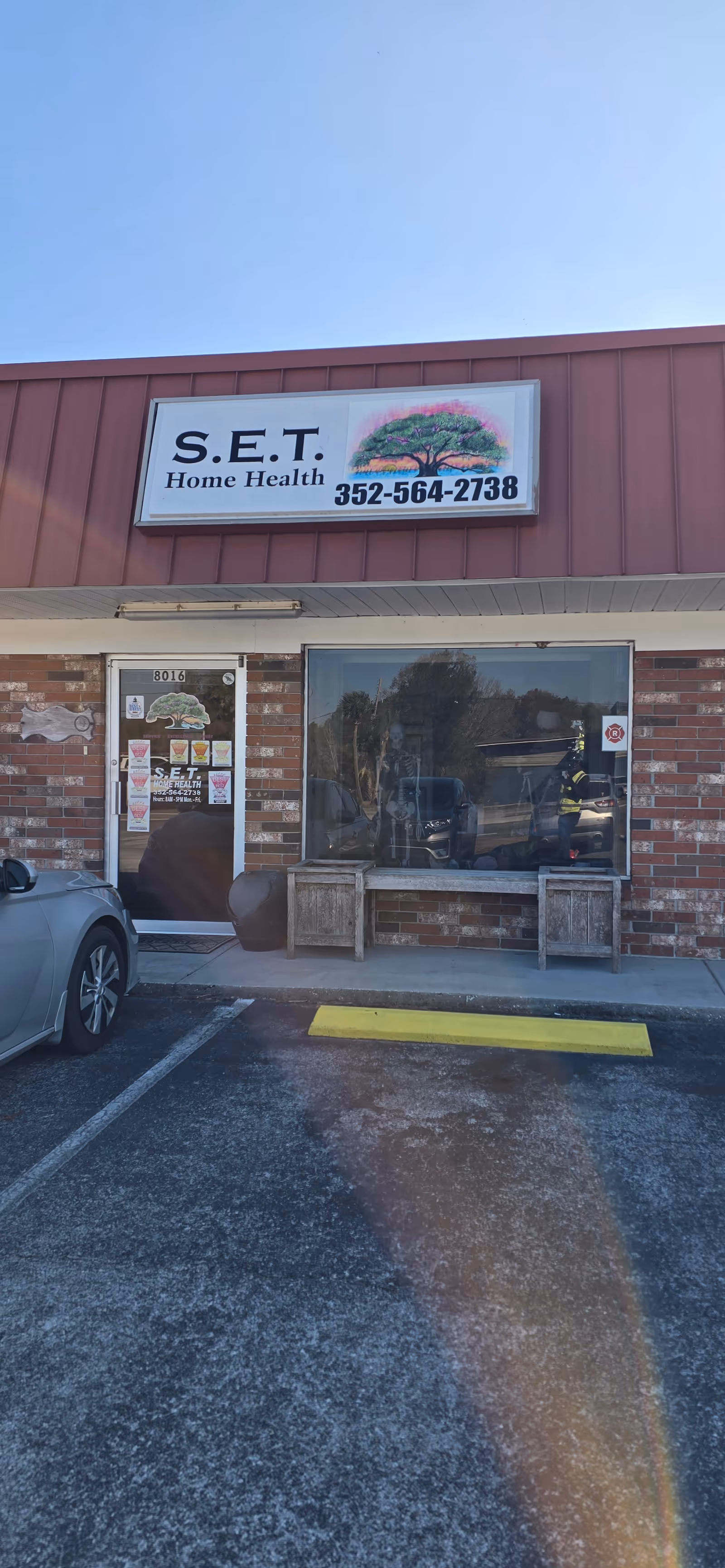 Front exterior of a brick building with S.E.T. Home Health sign and glass entrance.