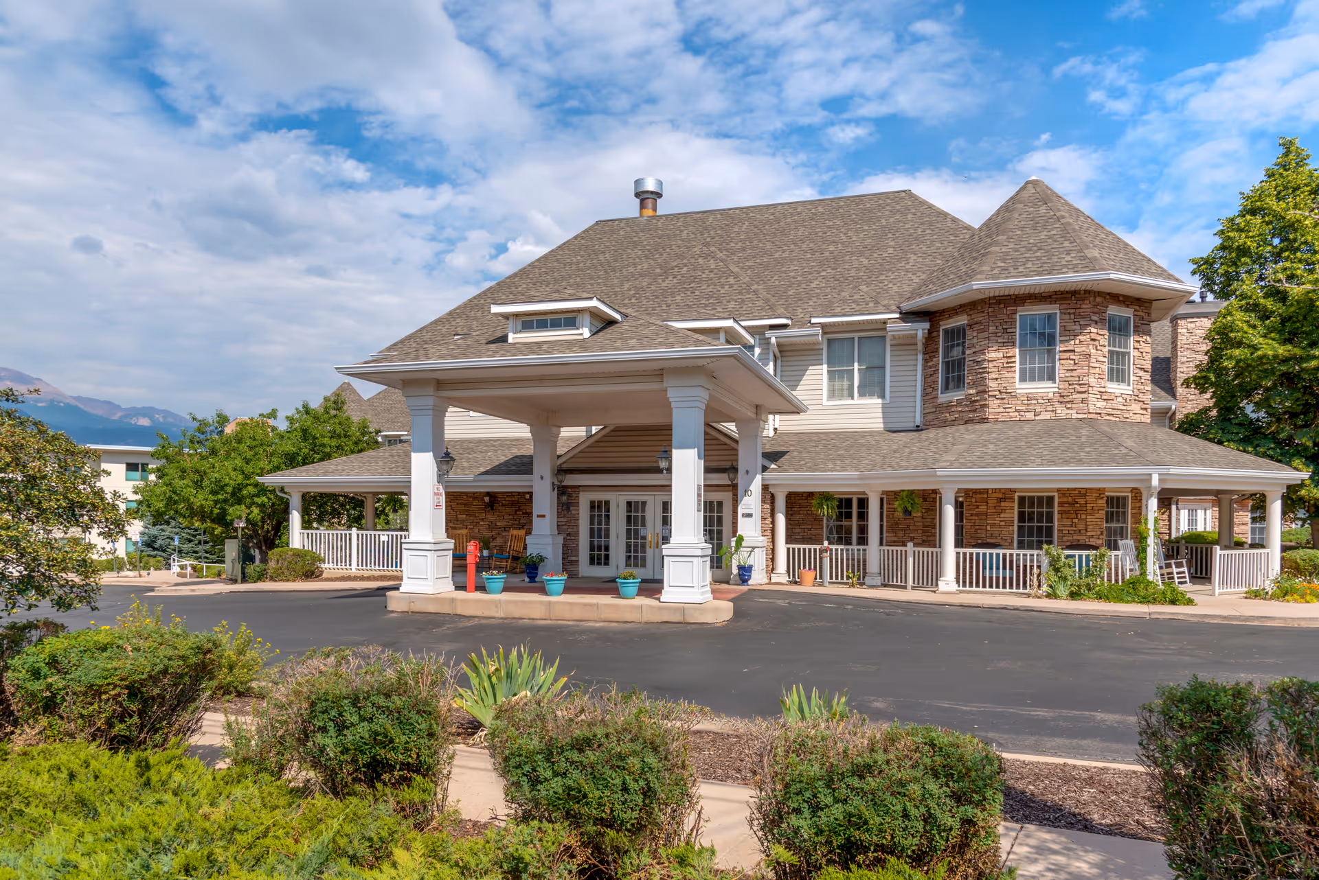 Exterior view of Brookdale Monument Valley Park, a large senior living facility with a covered entrance.