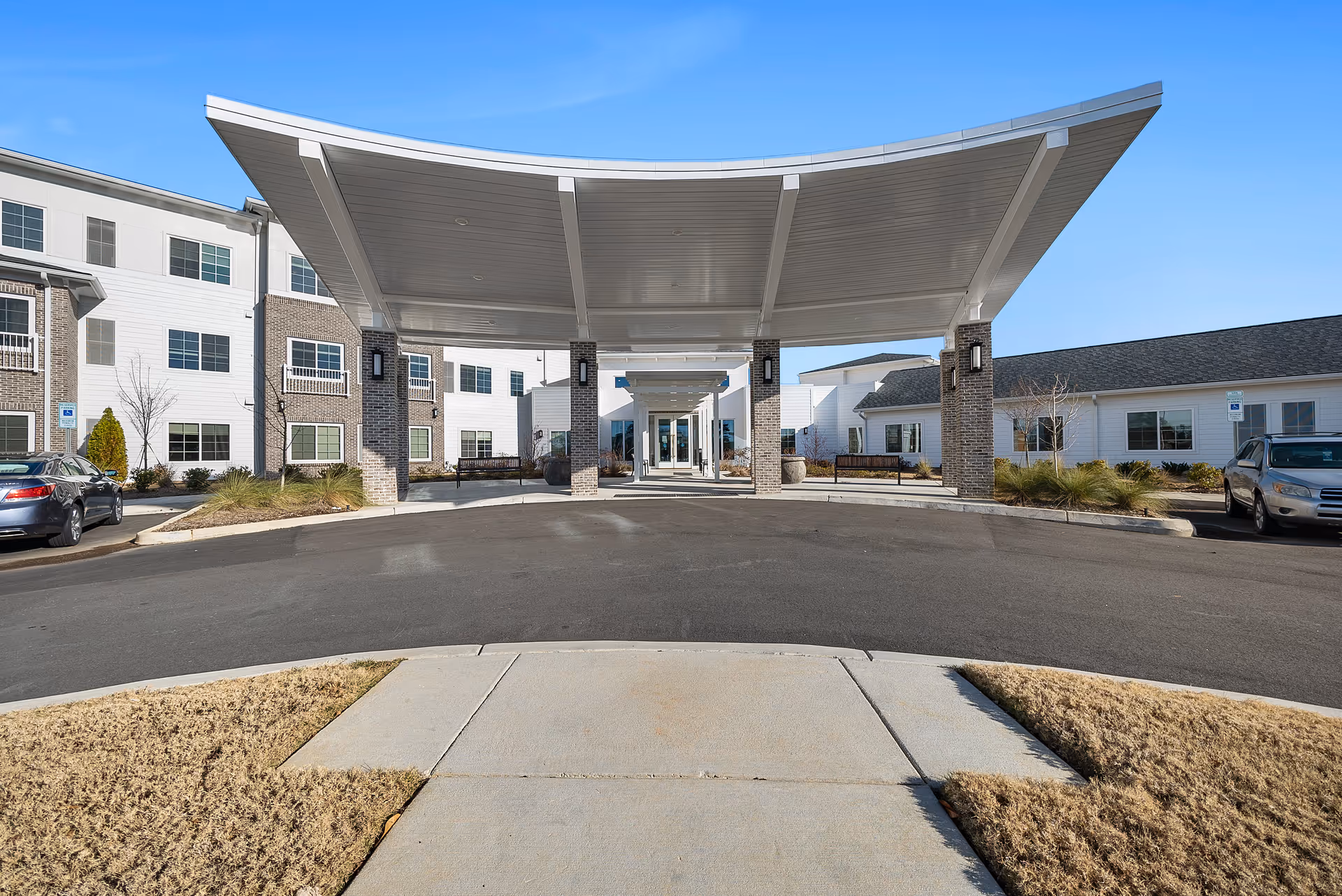 Front entrance of The Meridian at Carolina Lakes with a curved canopy and driveway.