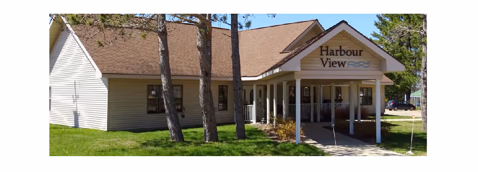 Front view of Harbour View Assisted Living Center entrance with a covered walkway.