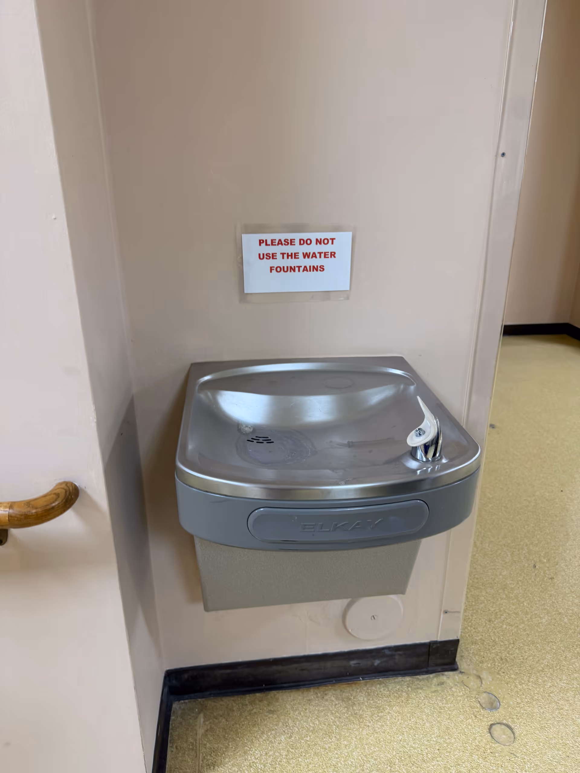 Indoor hallway water fountain with a 'Please do not use the water fountains' sign.