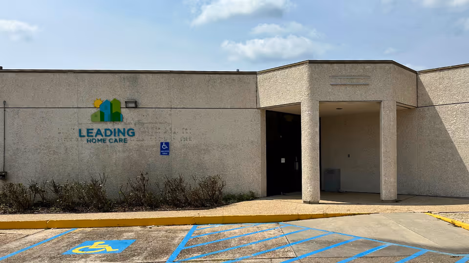 Exterior of Leading Home Care building with entrance and wheelchair accessibility sign.