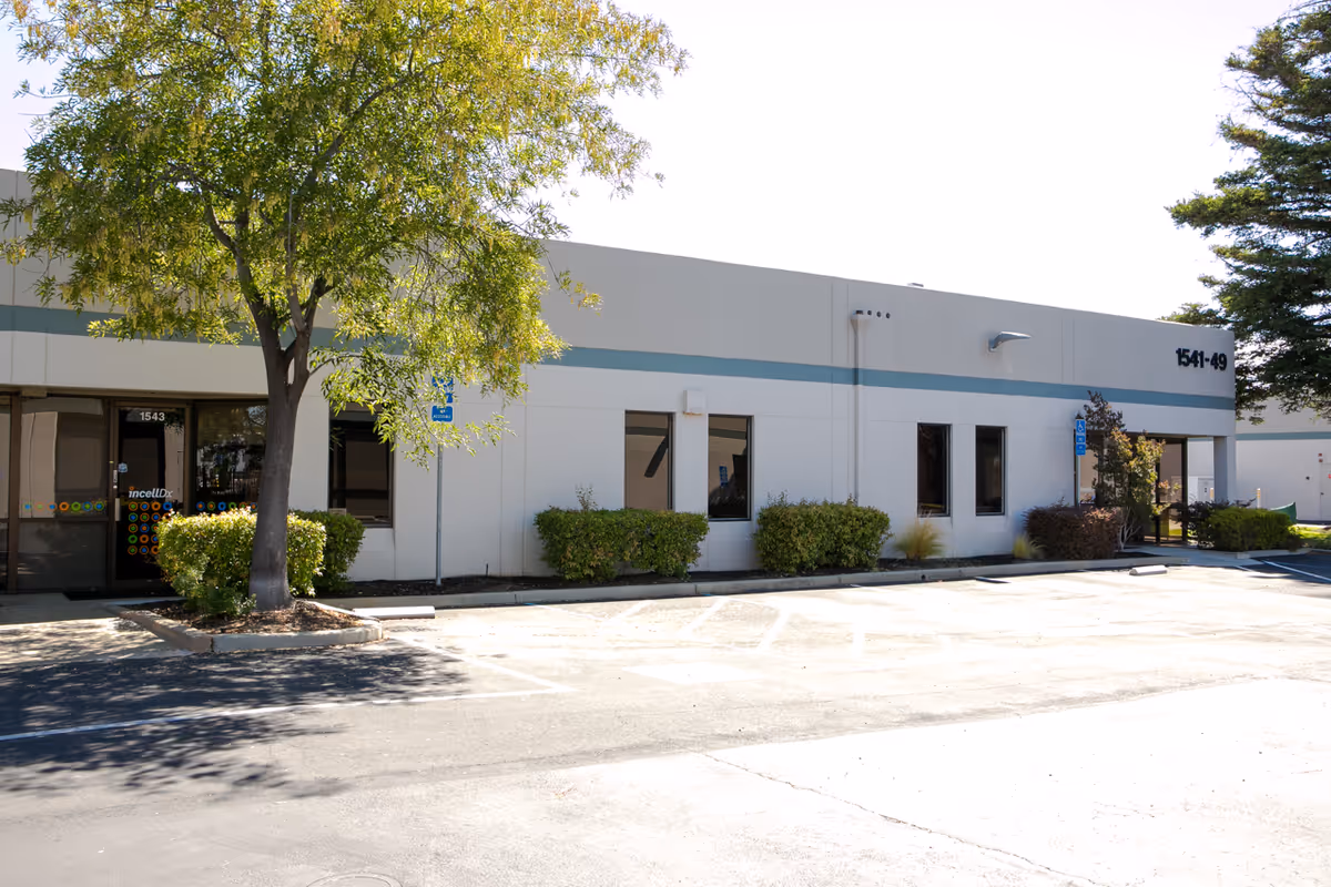 Exterior view of a single-story Incell Dx Inc facility with parking lot.