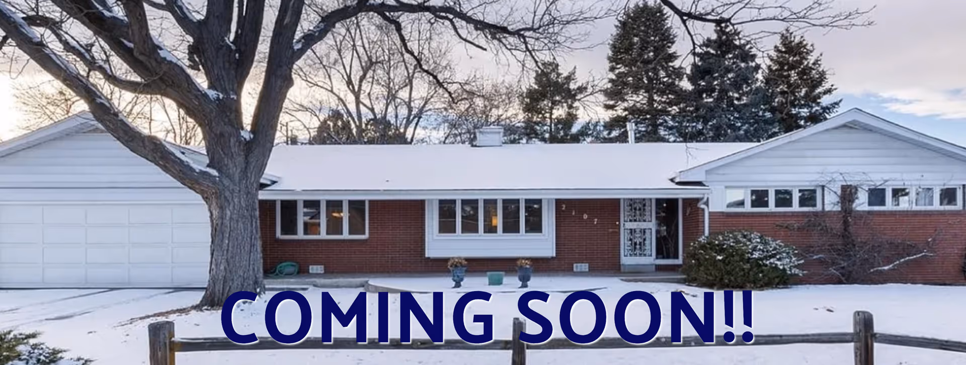 Snowy front of a single-story brick building with a large tree and COMING SOON overlay.