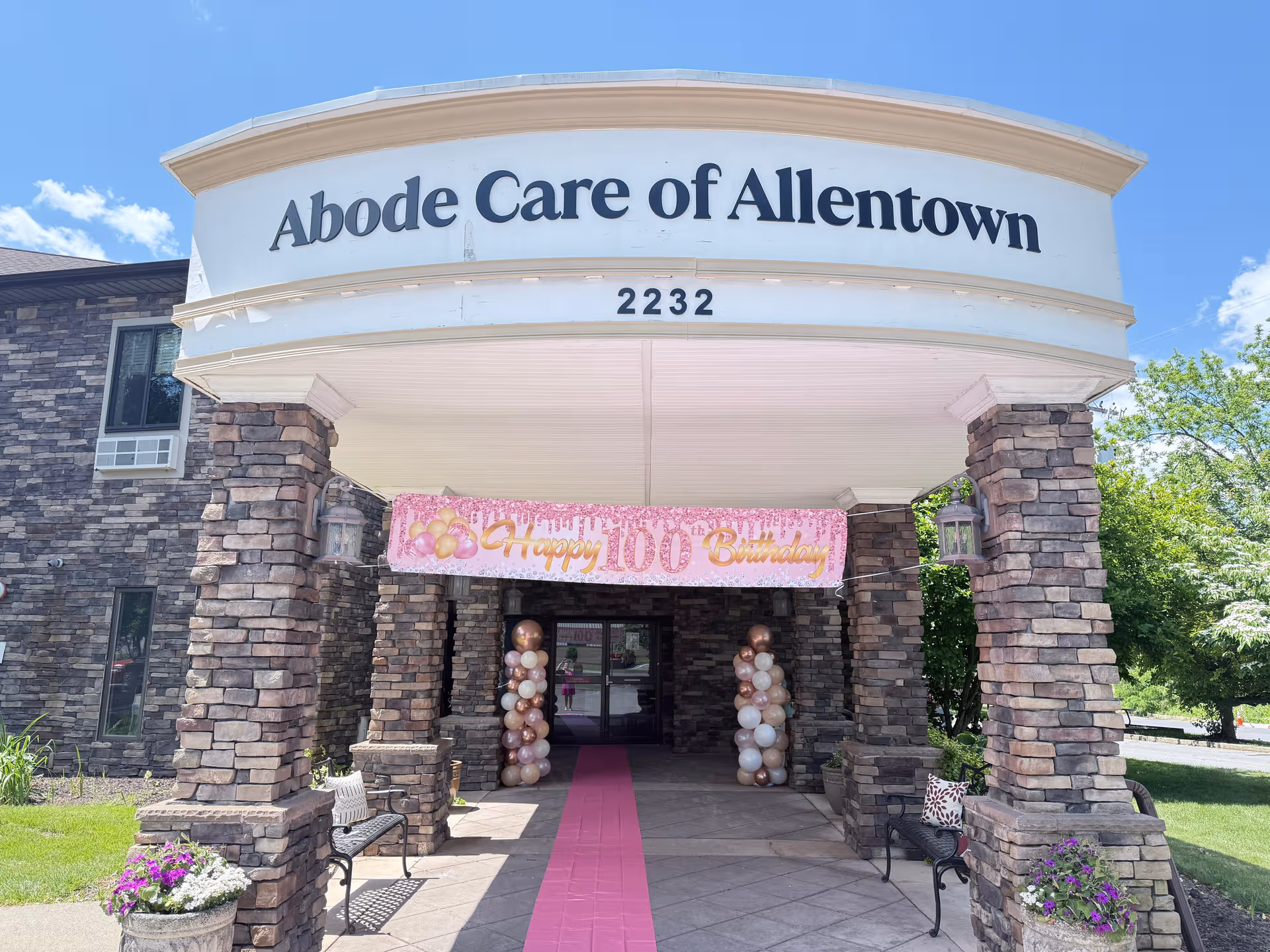 Front entrance of Abode Care of Allentown with pink birthday decorations and balloons.
