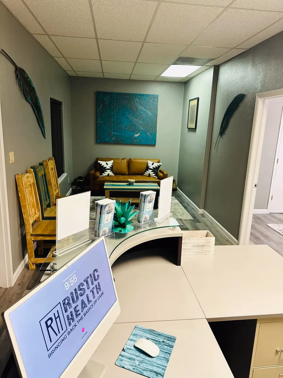 Reception desk in a modern senior care lobby with seating and artwork.