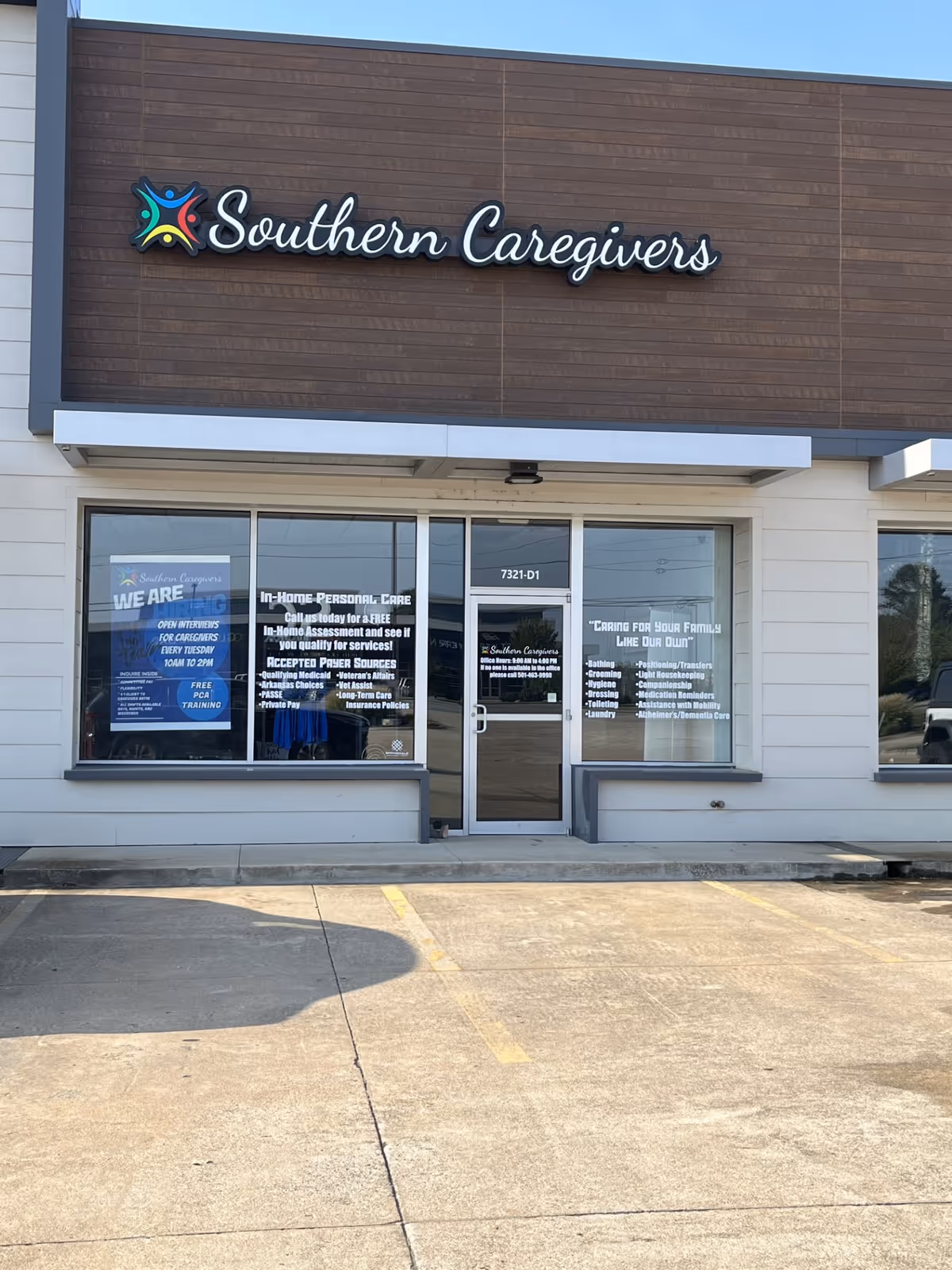 Front of a care facility storefront reading Southern Caregivers of NWA with glass doors.