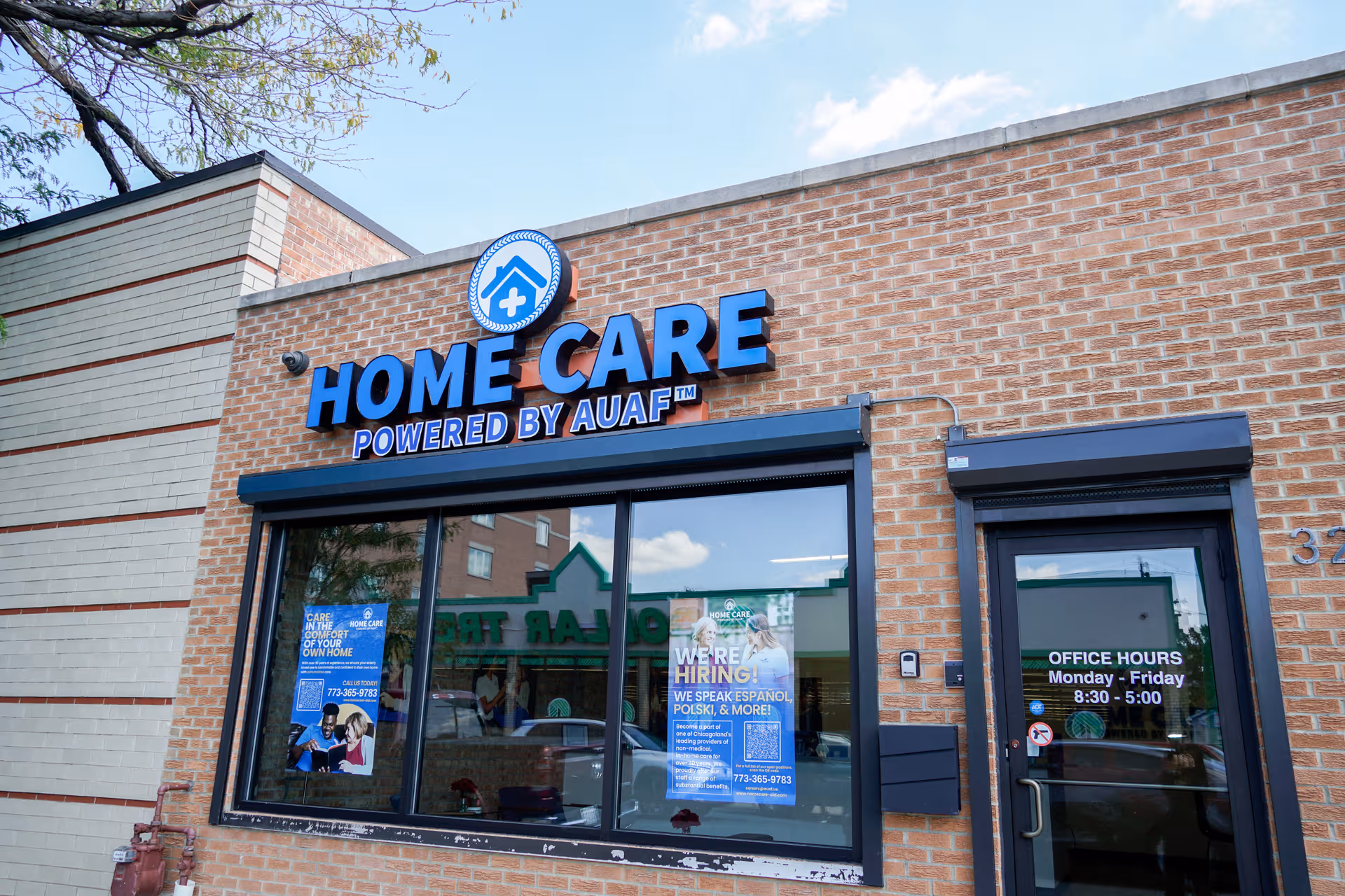 Brick storefront reading 'Home Care Powered by AUAF' with large front windows