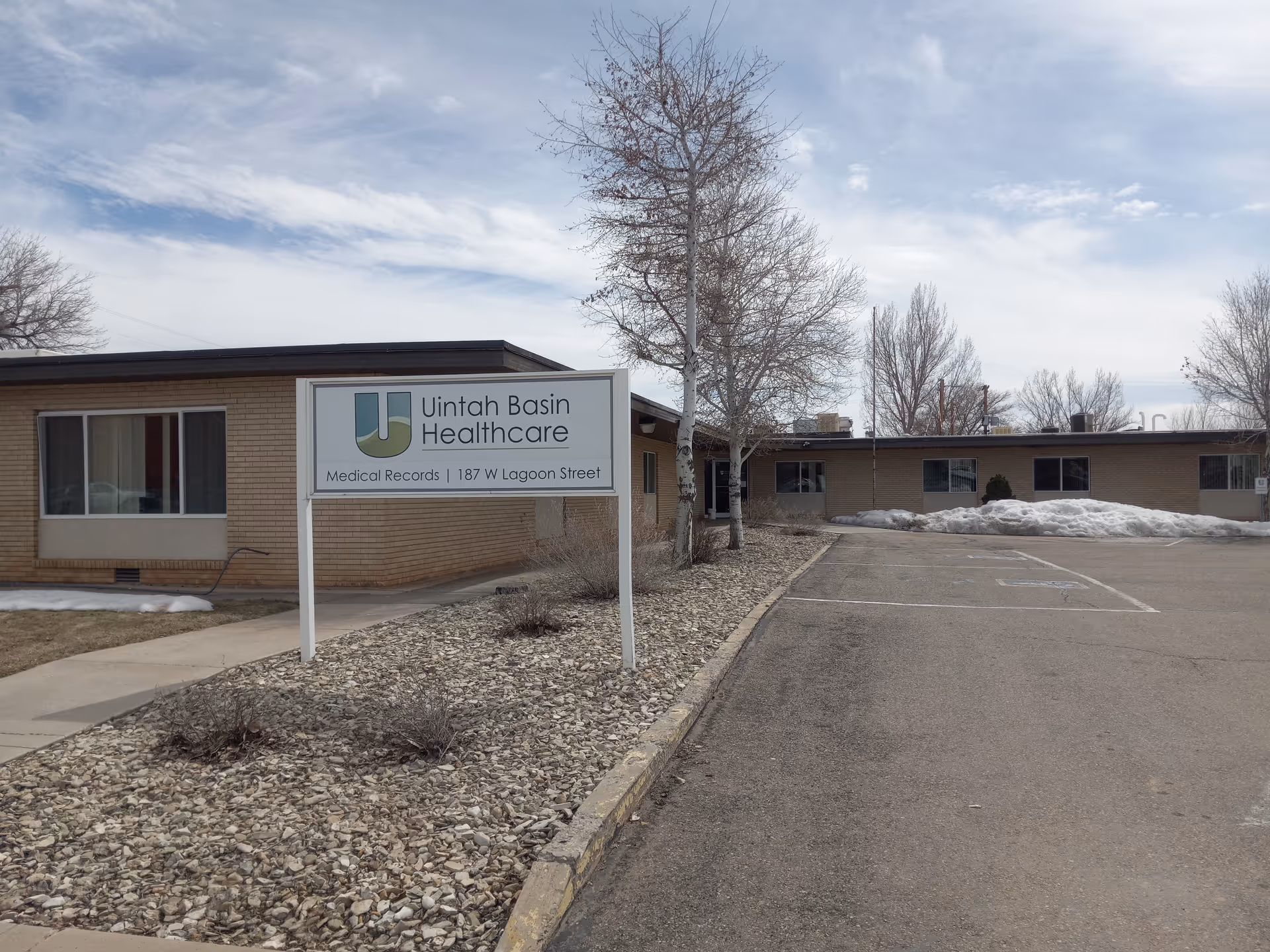 Exterior view of Uintah Basin Healthcare building with sign and adjacent parking lot.