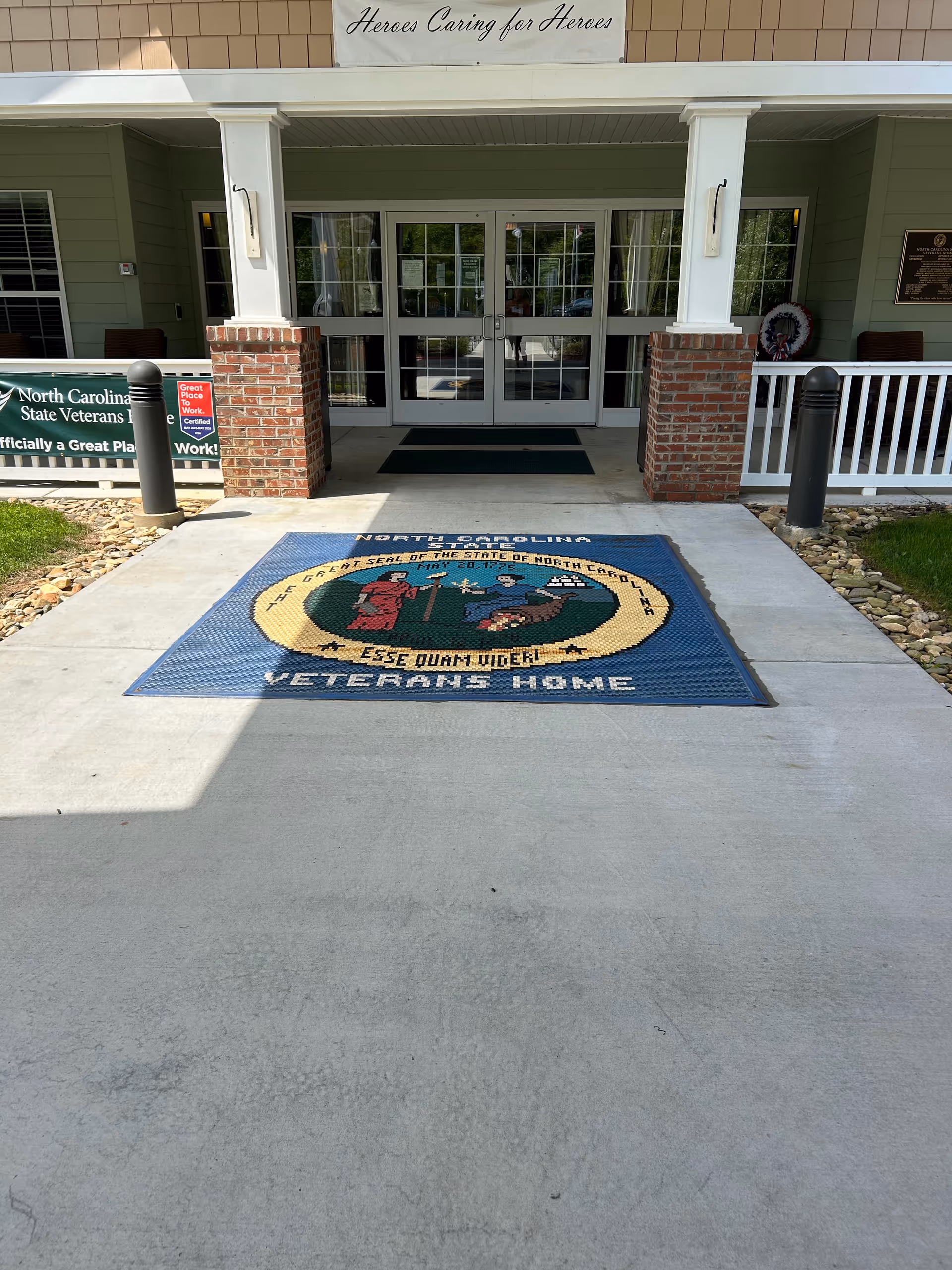 Front entrance of Nc State Veterans Home-Black Mountain with a 'Heroes Caring for Heroes' sign.