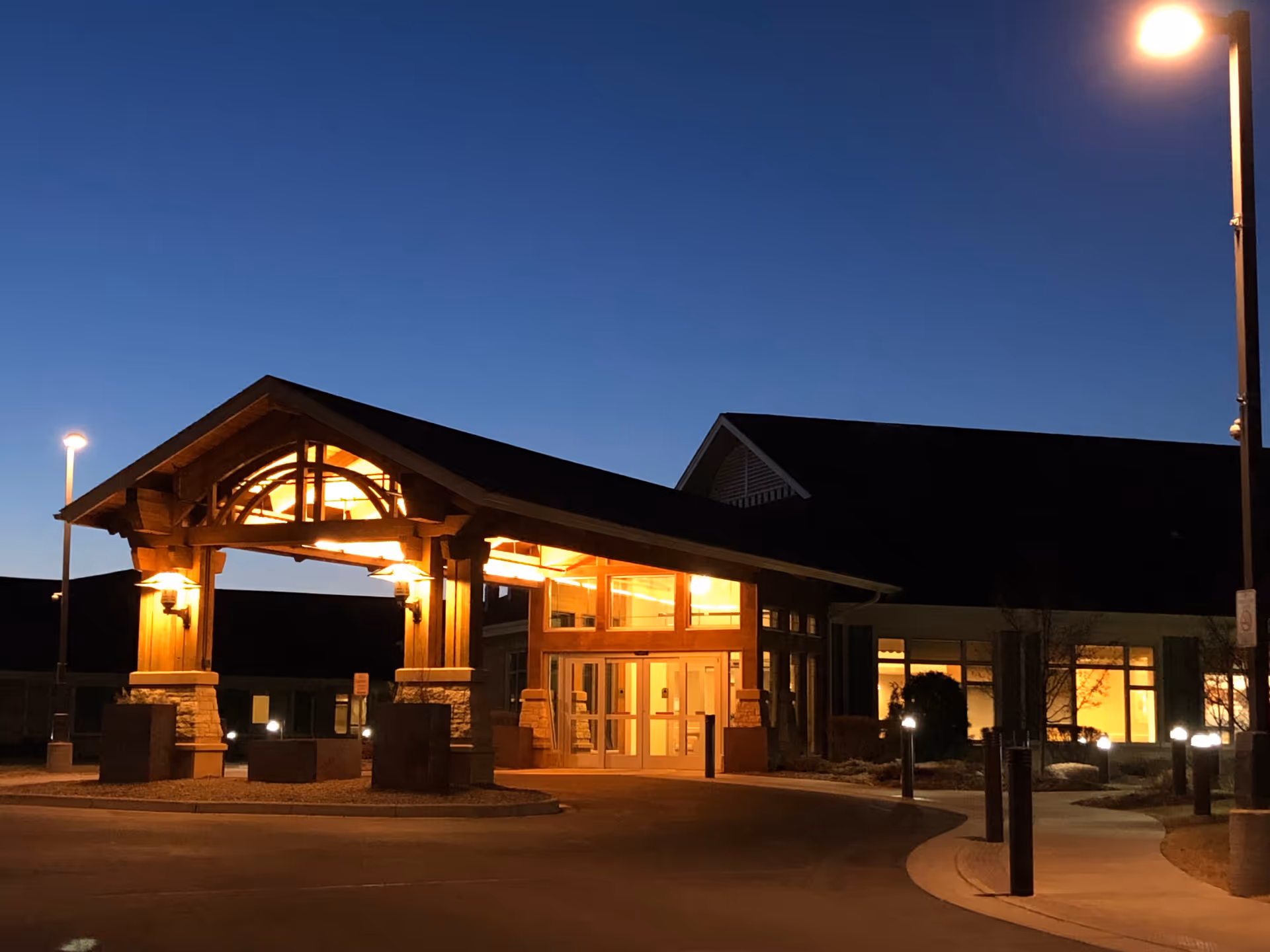 Exterior view of the Wisconsin Veterans Home at Chippewa Falls entrance at dusk.