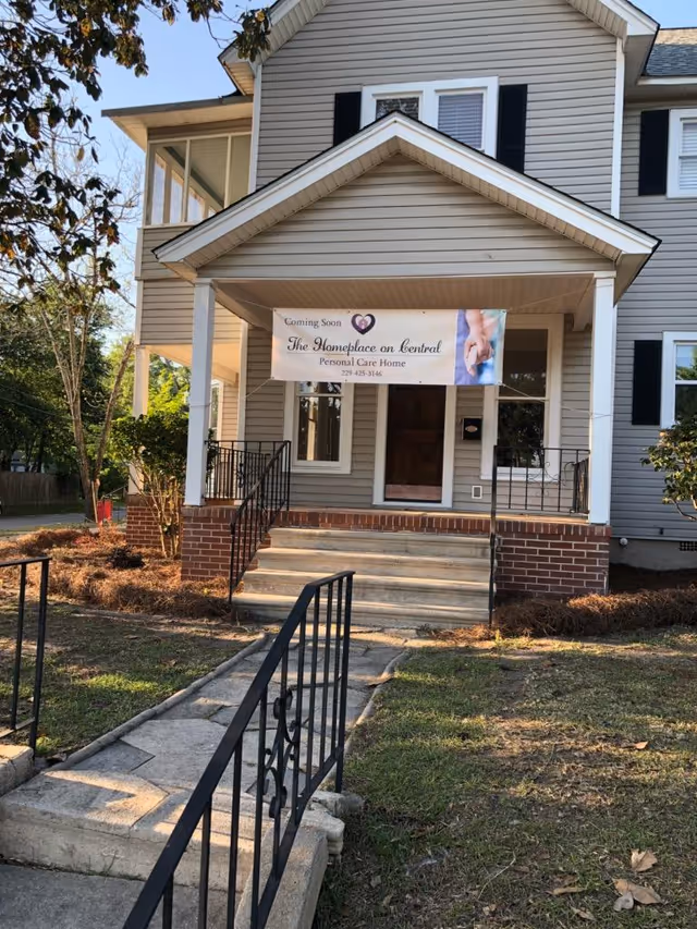 Front exterior of The Homeplace on Central with a banner over the entrance.