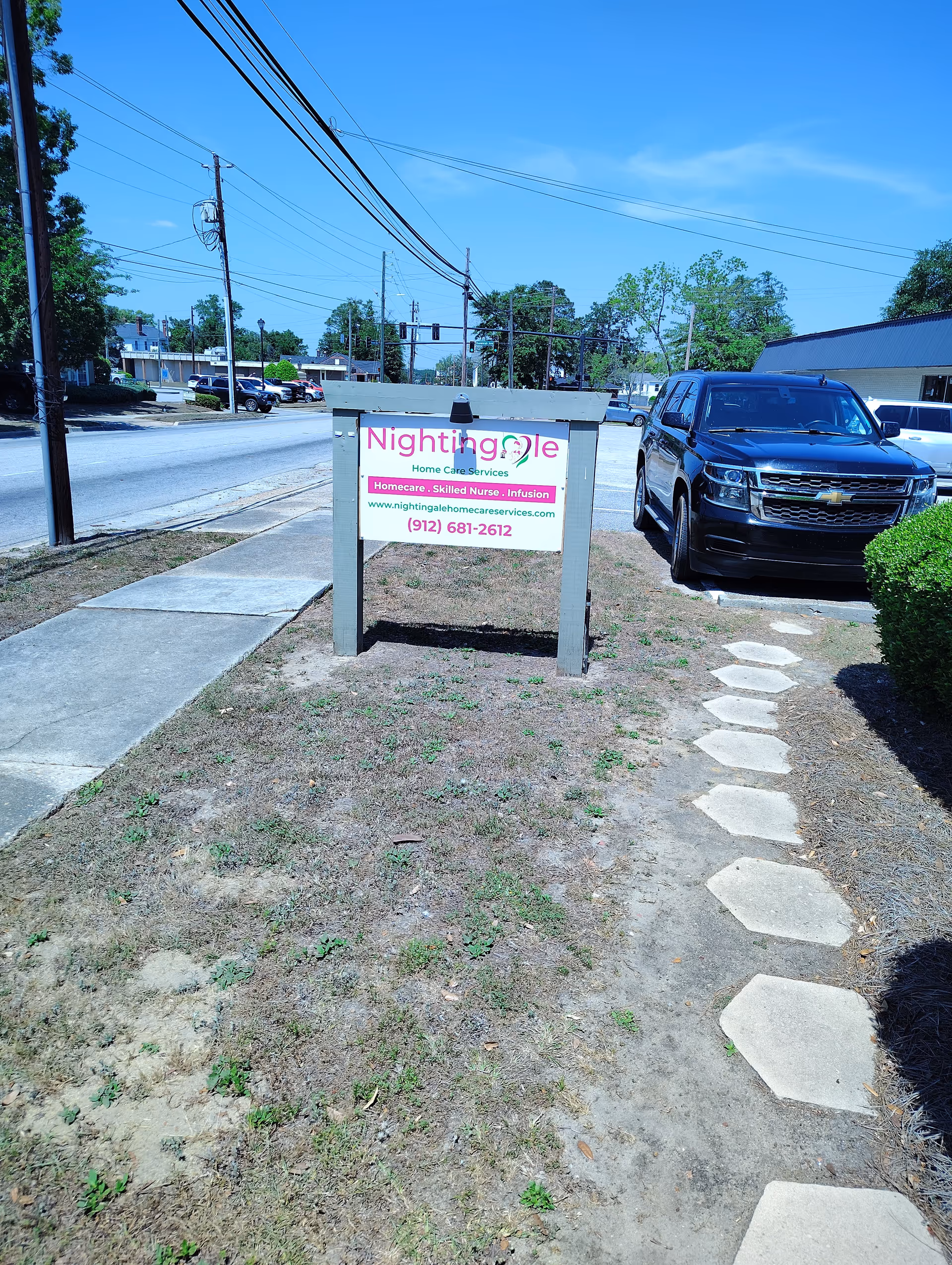 Outdoor view of Nightingale Home Care Services sign along the street.