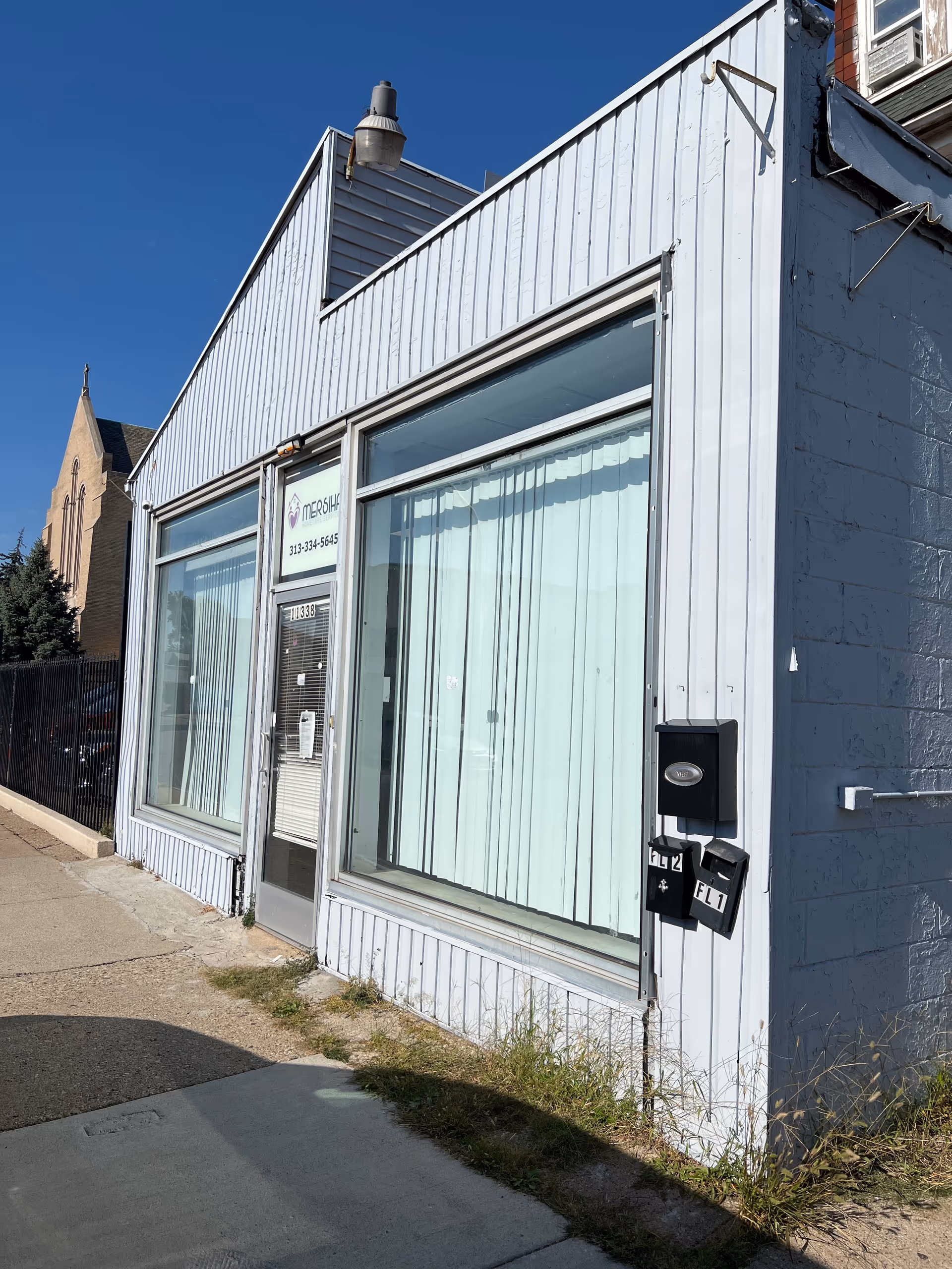Exterior view of a storefront with large windows and Mersiha Homecare Services sign.