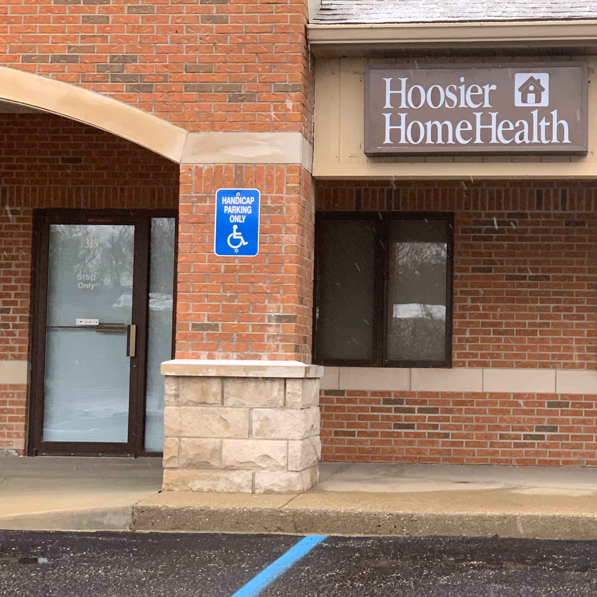 Exterior of Hoosier Home Health building with handicap parking sign.