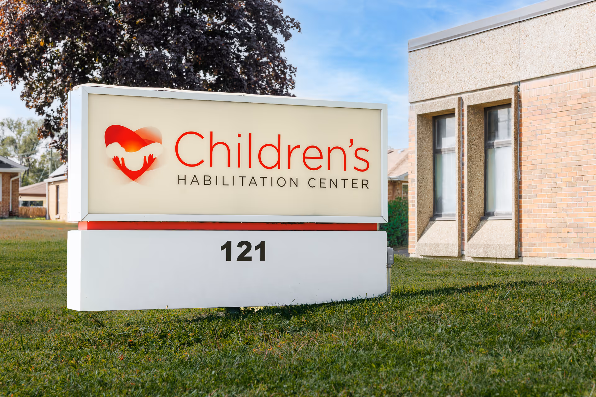 Outdoor view of a building front with a large sign reading Children's Habilitation Center and 121.