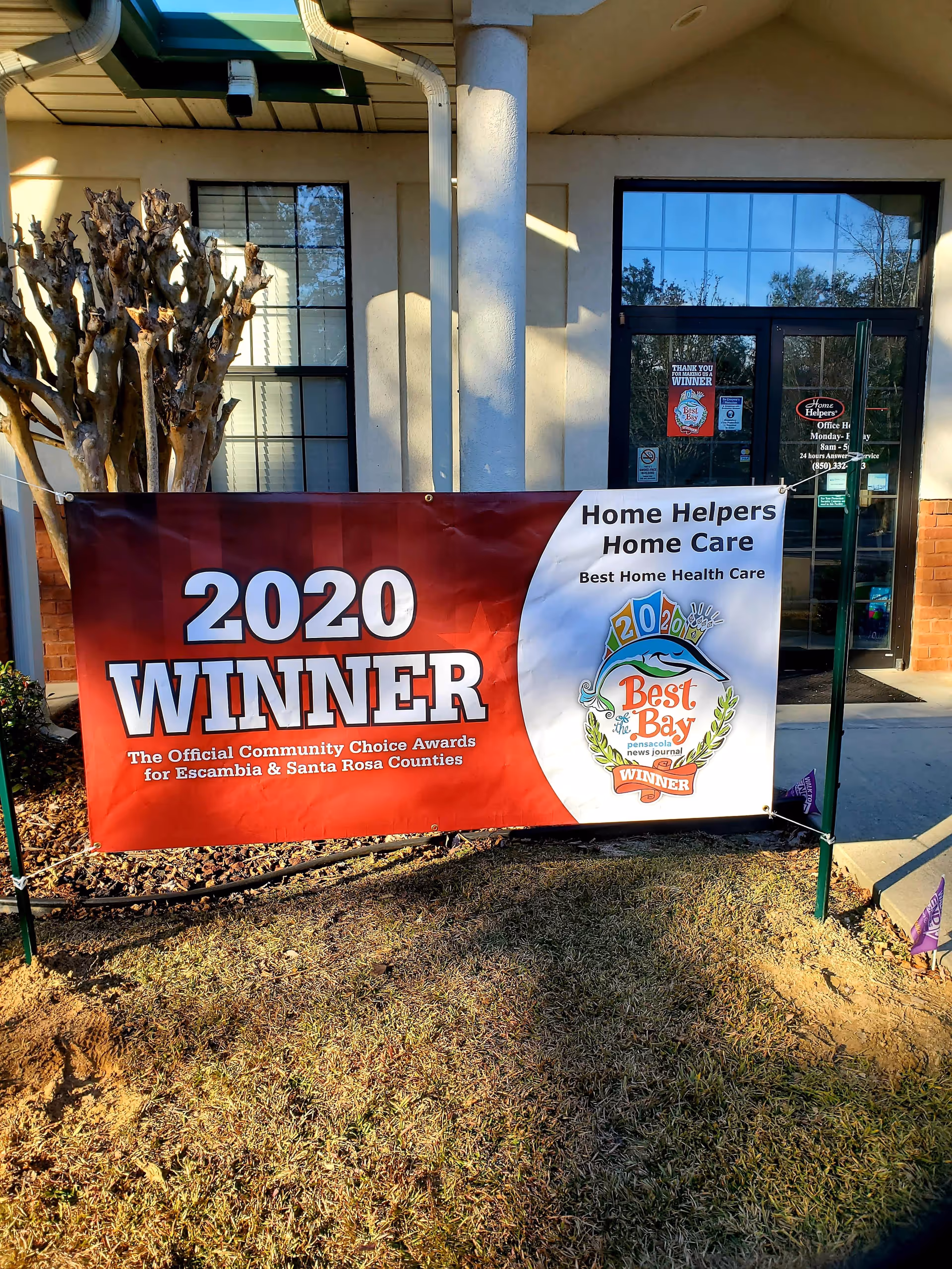 Exterior of Home Helpers Home Care Pensacola with a large 2020 winner banner.