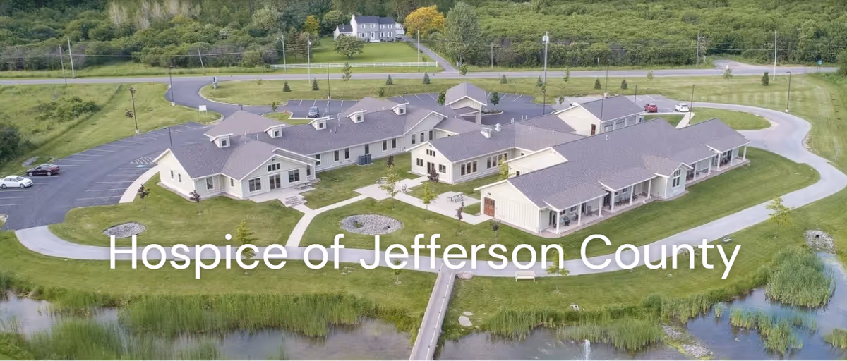 Aerial view of the Hospice of Jefferson County campus with beige buildings and greenery.