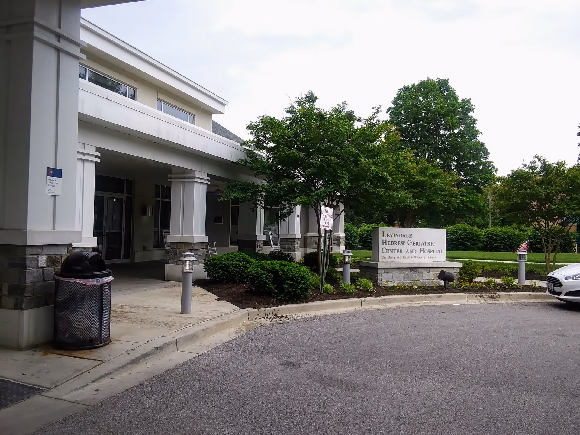 Exterior view of Levindale Hebrew Geriatric Center & Hospital entrance with trees and driveway