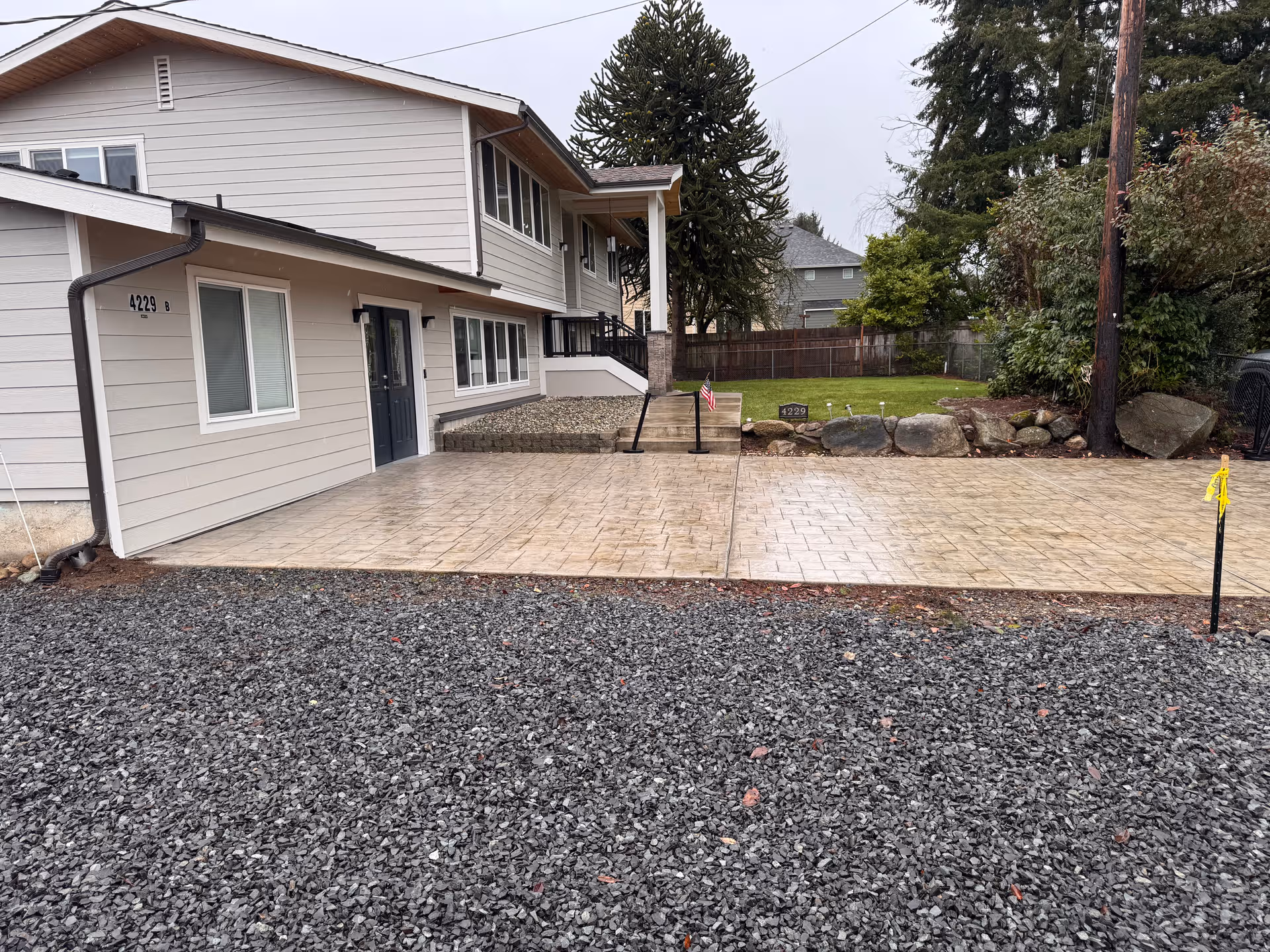 Exterior view of a beige senior living facility with a paved front driveway.