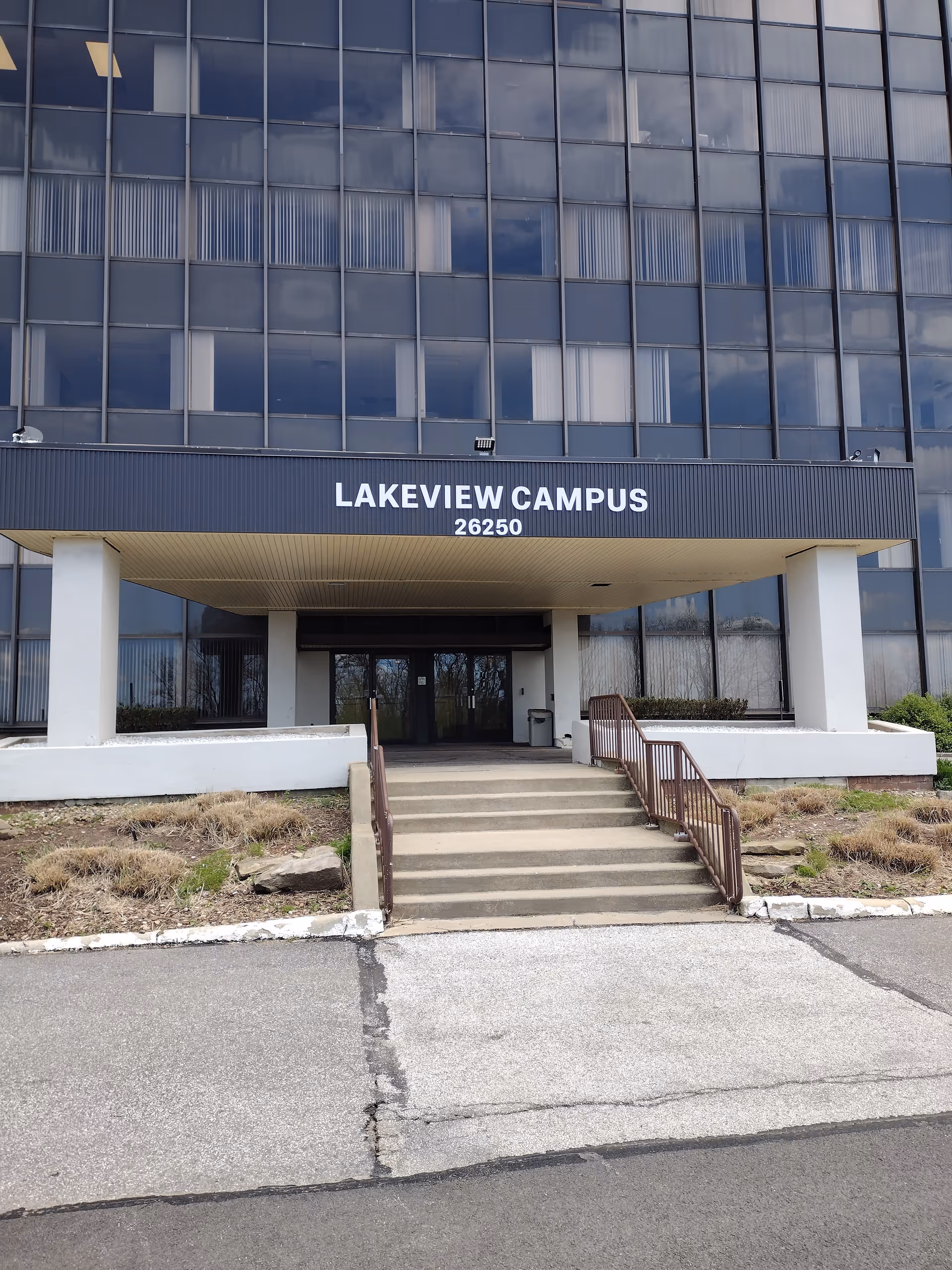 Multi-story glass building with a covered entrance and stairs reading Lakeview Campus