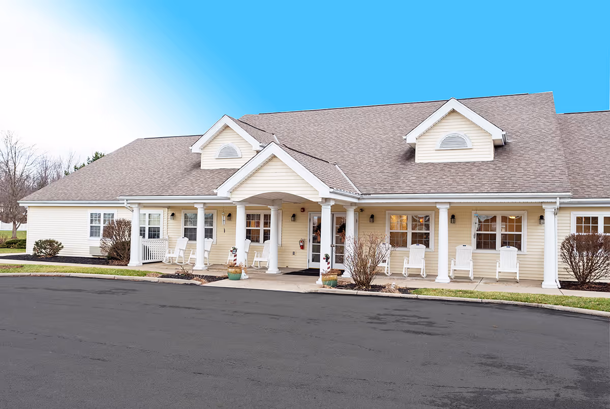 Barnes Place senior living facility front exterior with porch and white rocking chairs
