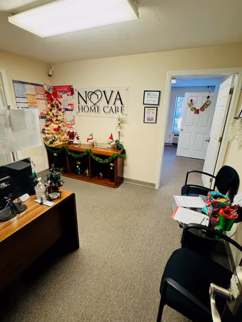 Reception area showing Nova Home Care sign, Christmas decorations, desk, and seating.