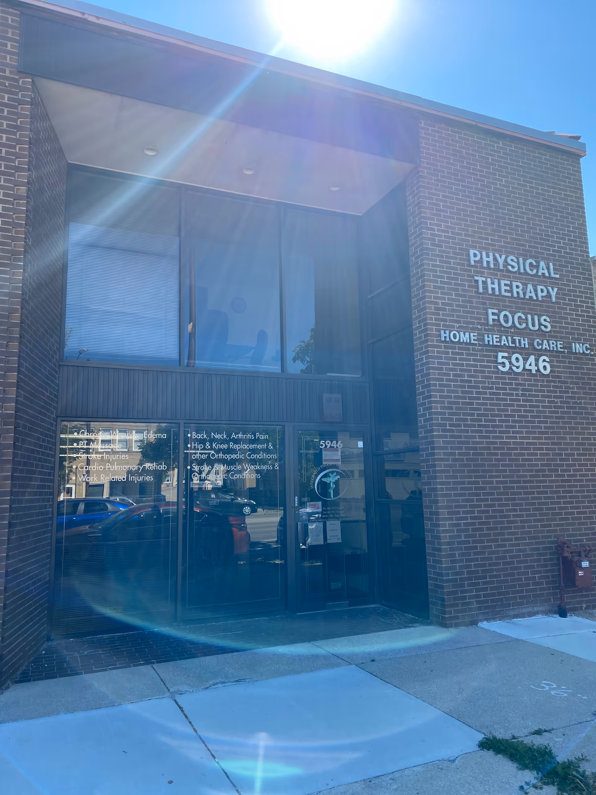 Brick building entrance with glass doors and Focus Physical Therapy/Home Health Care sign on the right.