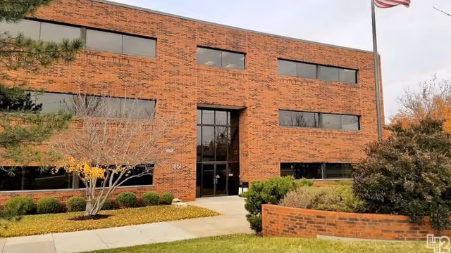ClearPath facility front: brick exterior with glass entry, flagpole, and landscaped greenery.