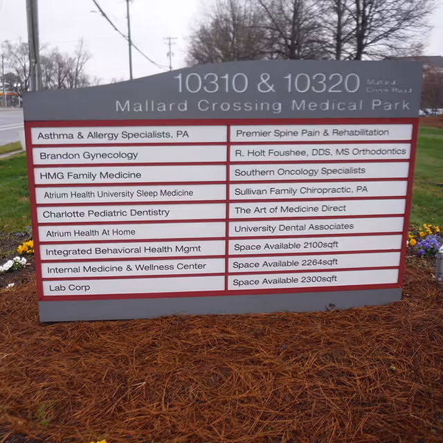 Outdoor signboard listing medical tenants at Mallard Crossing Medical Park