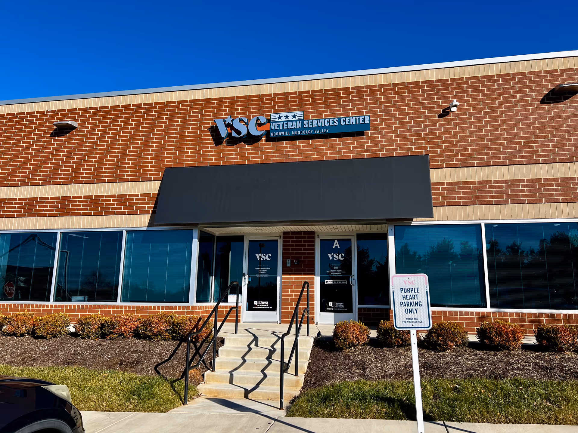 Brick building front with VSC Veterans Services Center sign and accessible entry stairs.