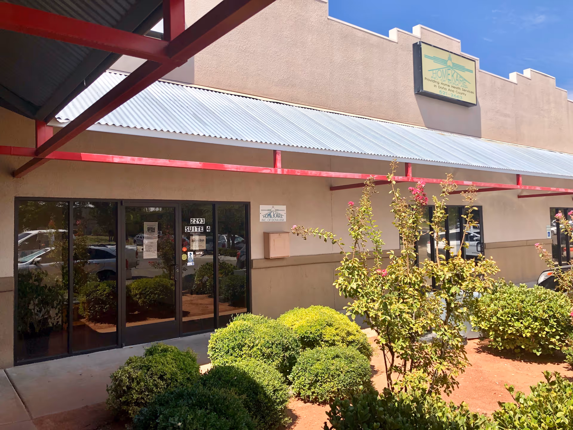 Exterior view of Home Kare Inc of Dona Ana facility with storefront doors and landscaping.