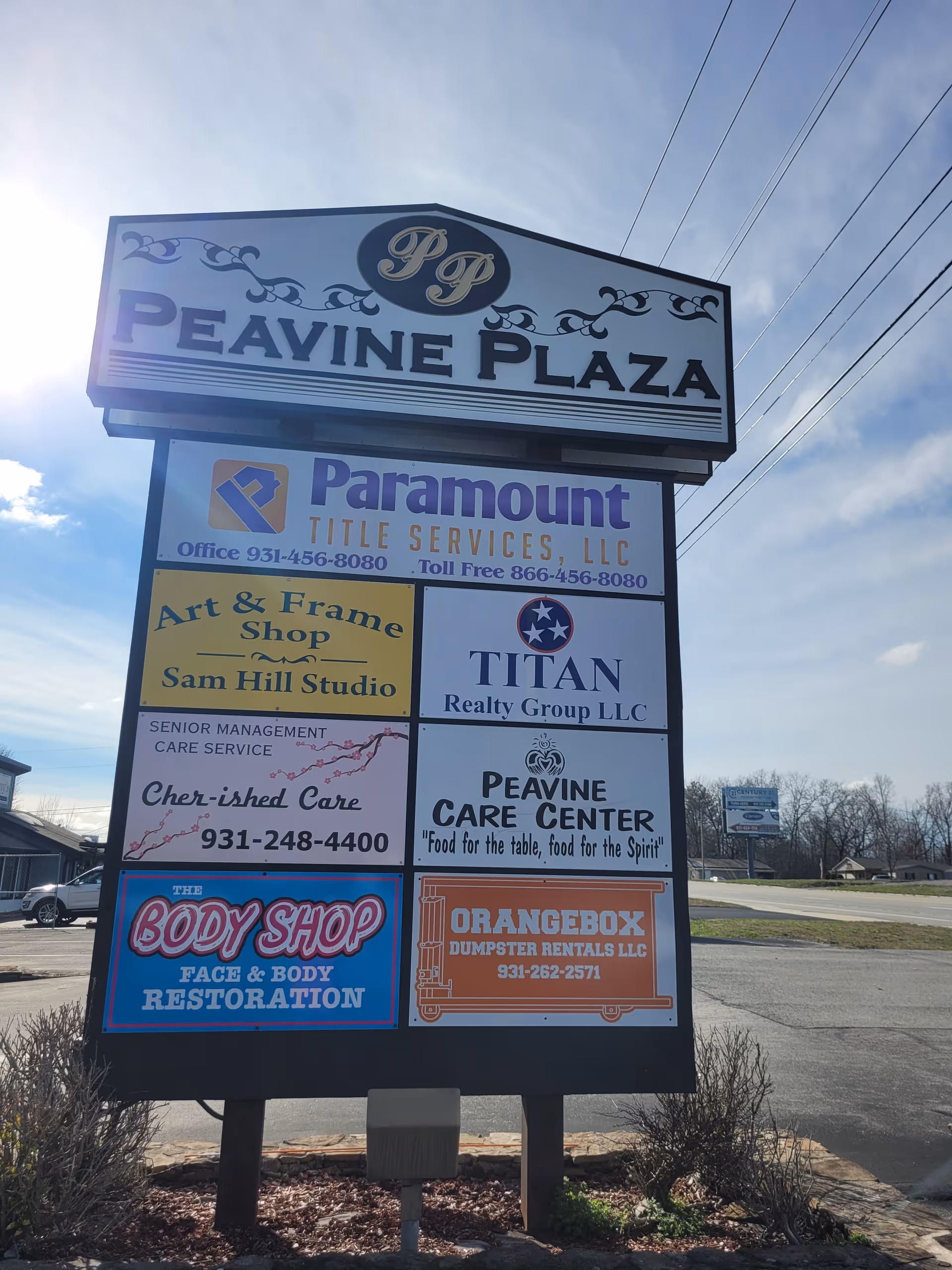 Outdoor multi-tenant signboard displaying Cher-ished Care among other businesses at Peavine Plaza.