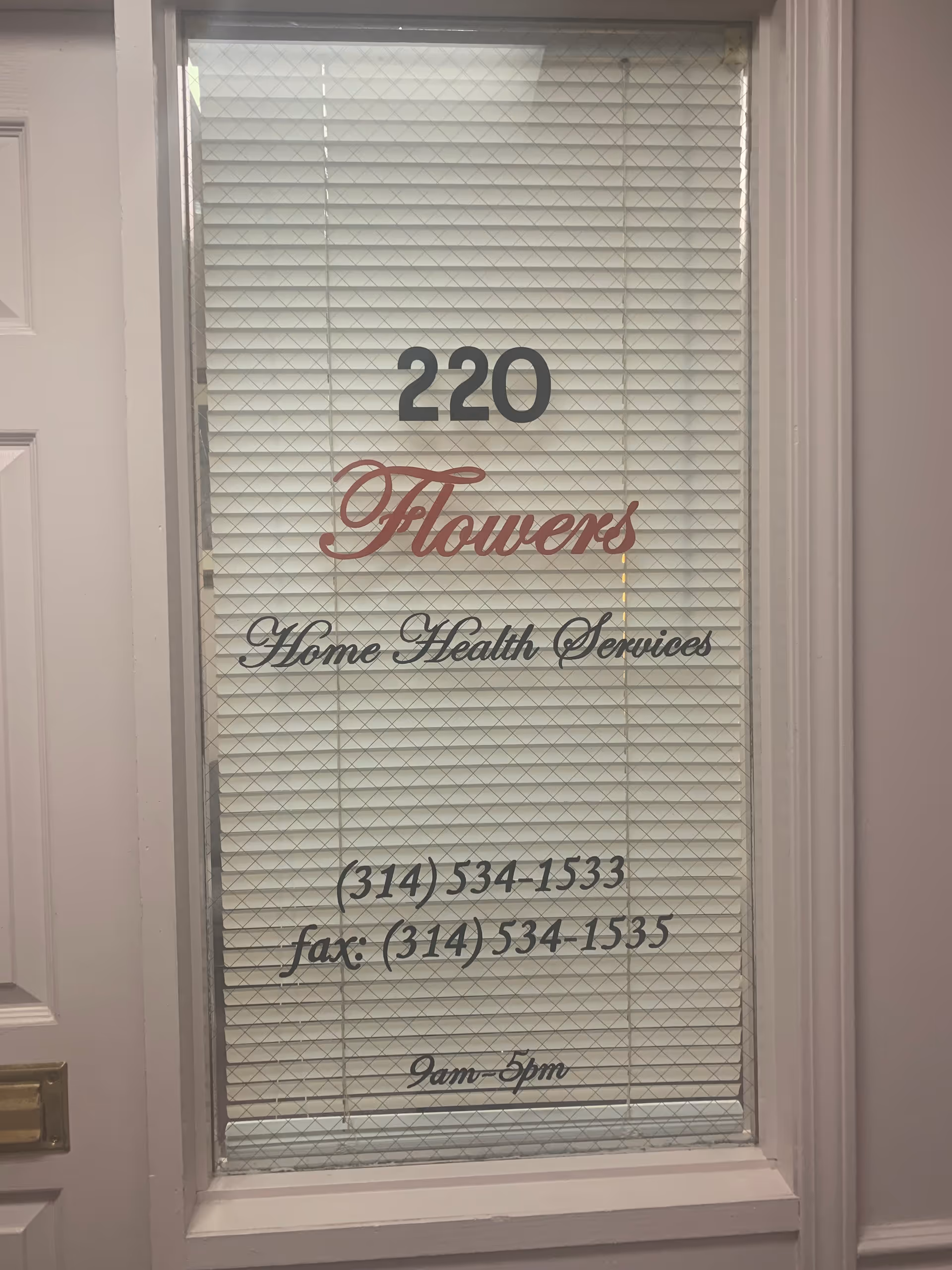 Door with blinds displaying 'Flowers Home Health Services' and contact information.