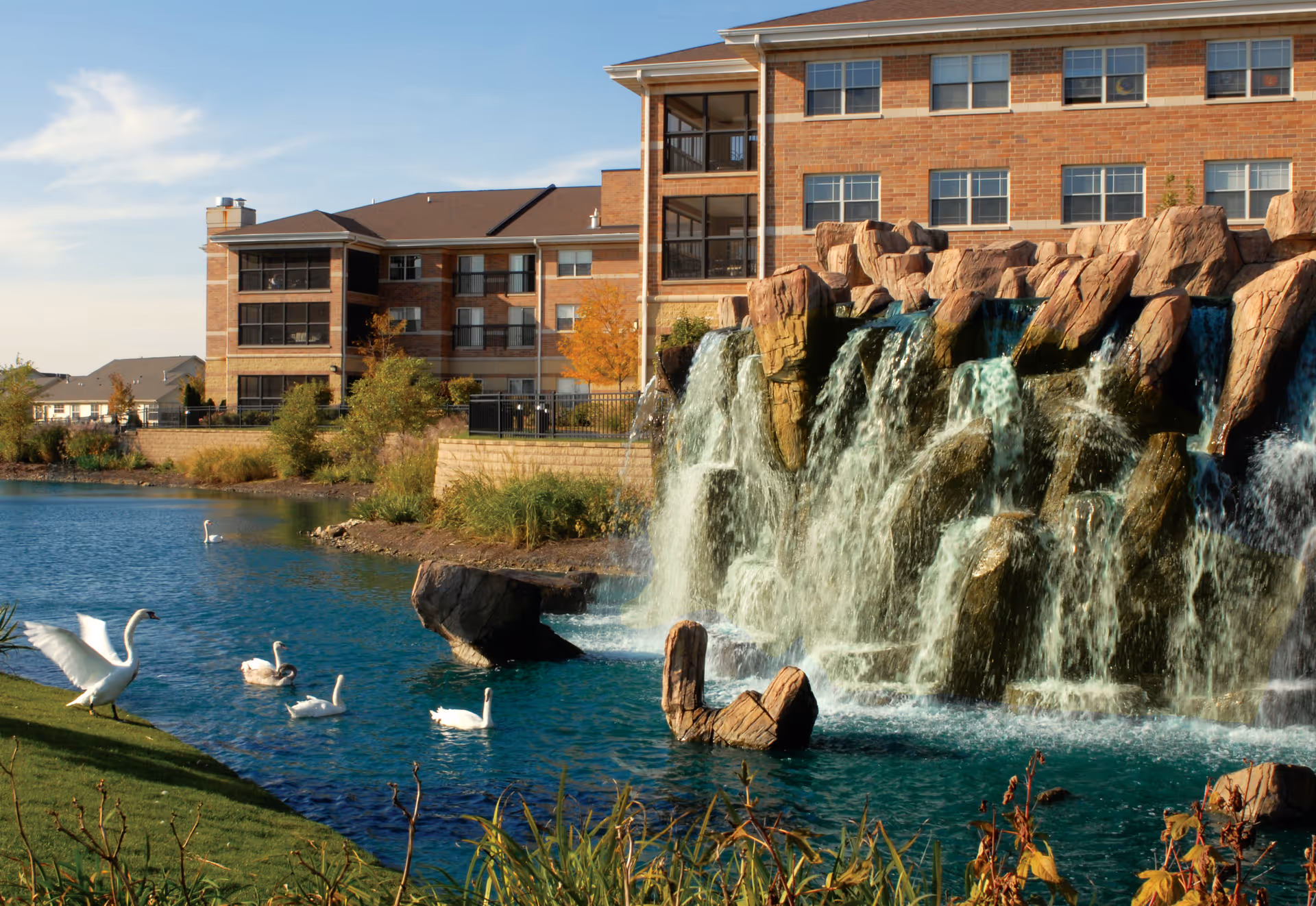 Exterior view at Alden of Waterford featuring a rocky waterfall and pond.