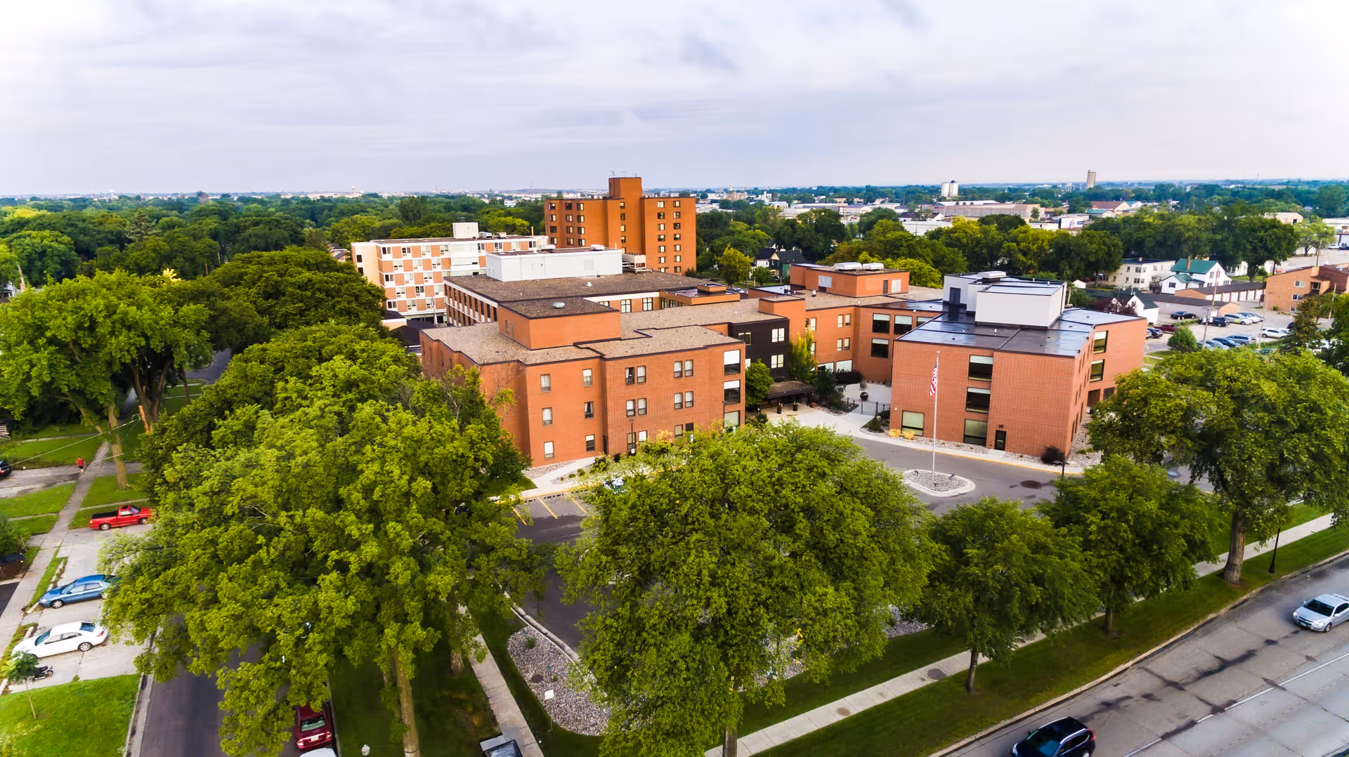 Aerial view of Bethany on 42nd campus with brick buildings and lush trees.