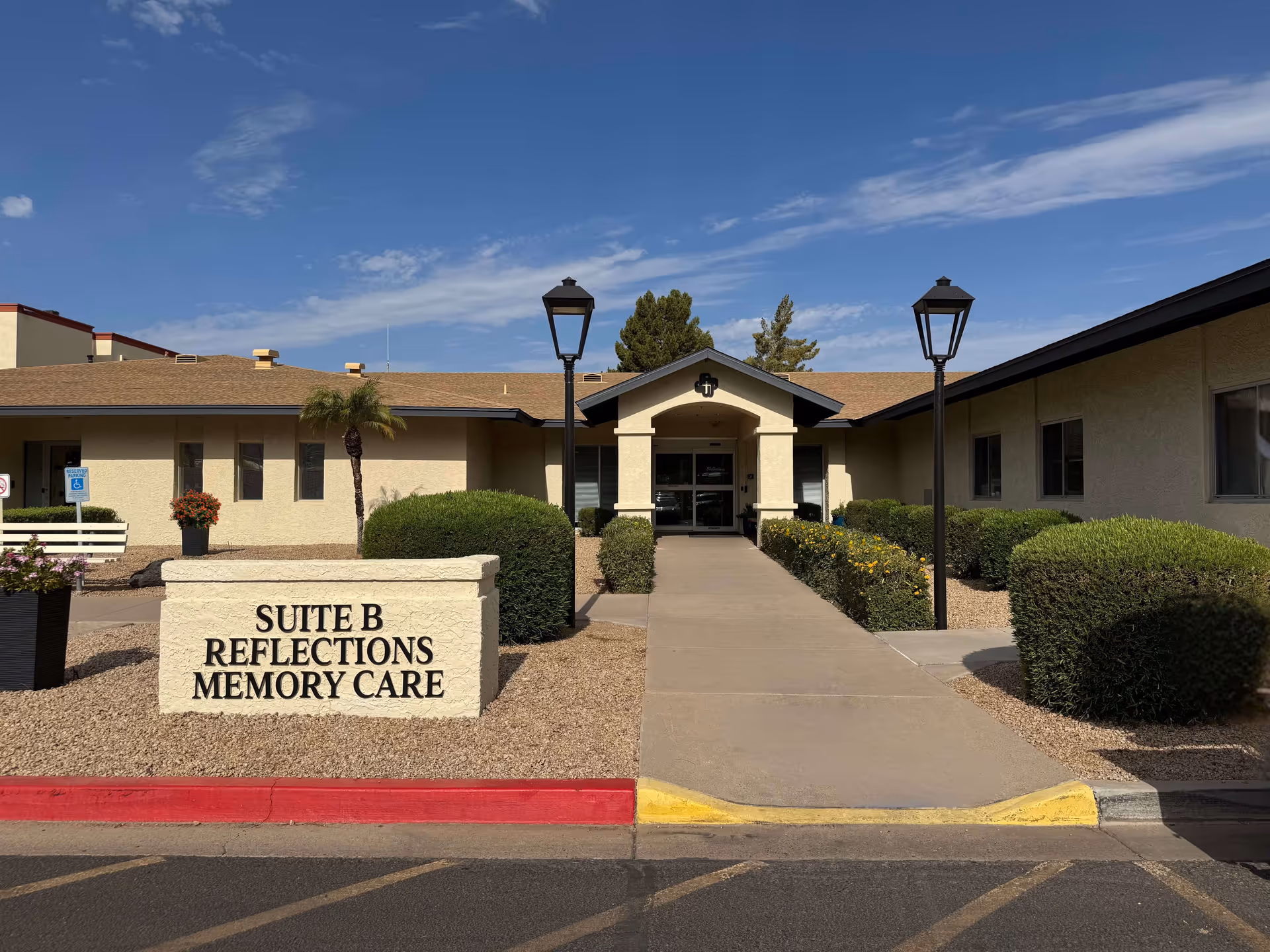 Front view of a memory care facility entrance with a sign reading Suite B.