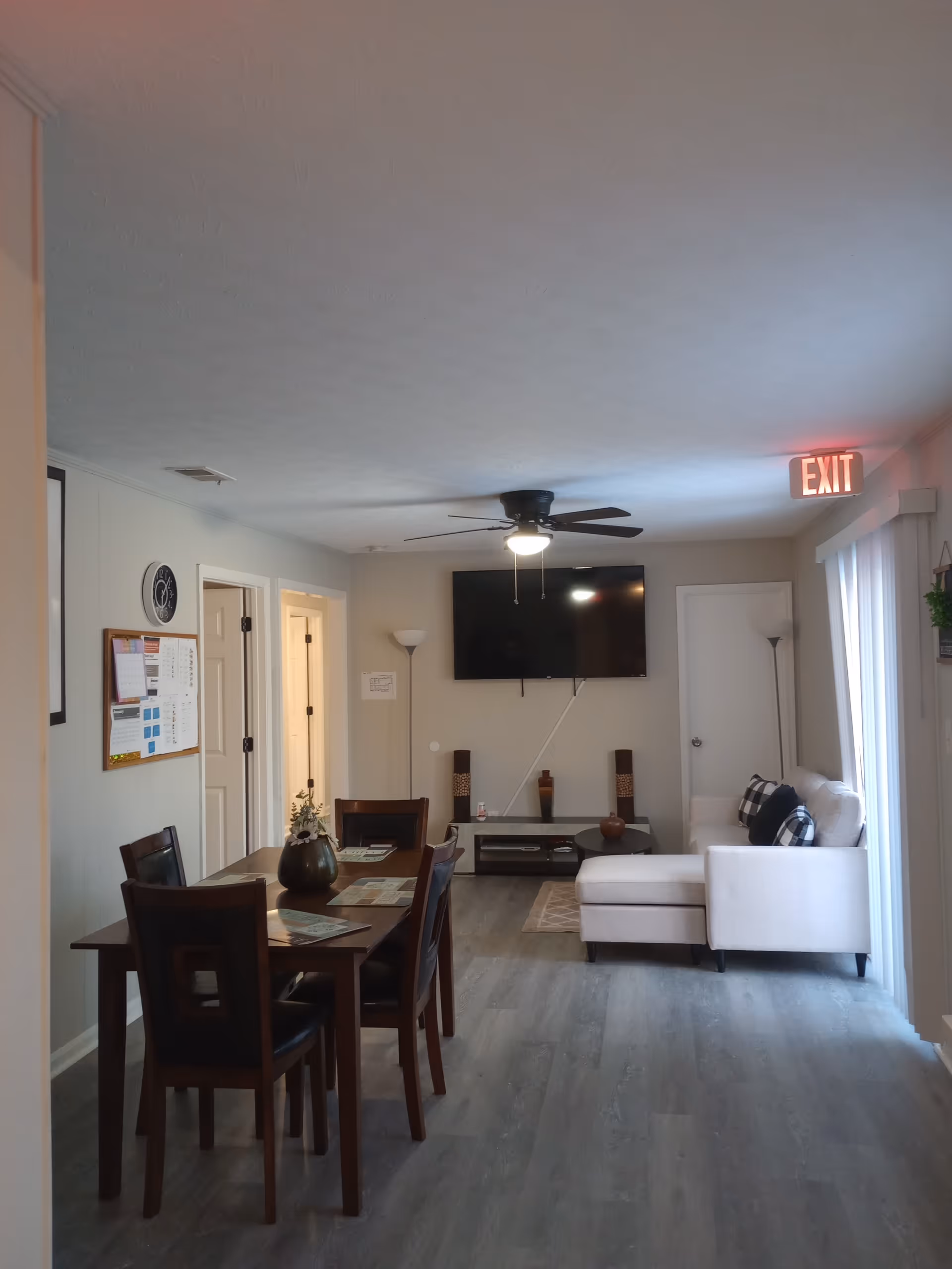 Interior living and dining area in a senior facility with a sofa and TV.