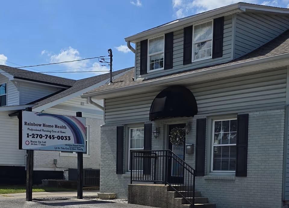 Exterior view of Rainbow In-Home Personal Care facility with entrance and sign.