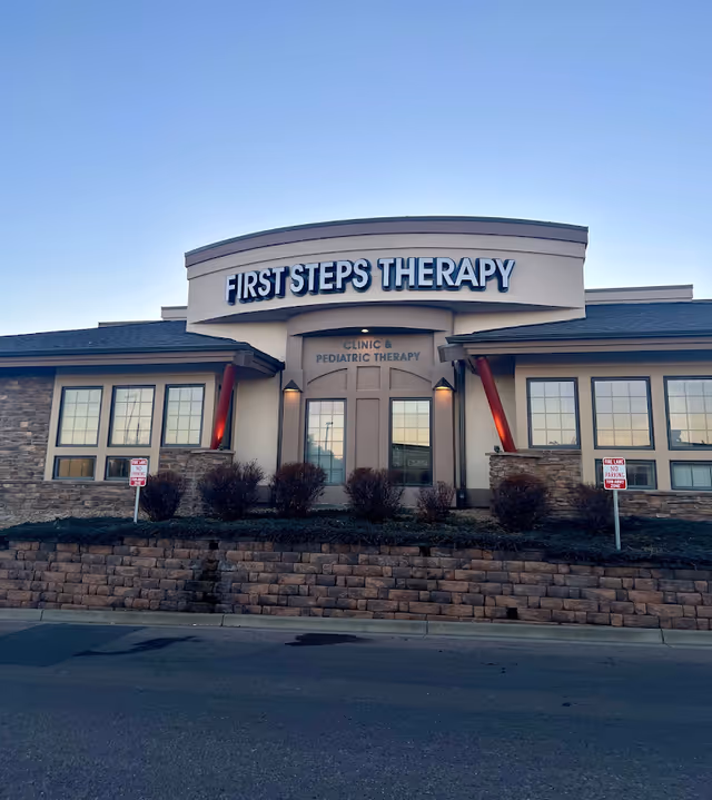 Front exterior of a clinic building with a prominent First Steps Therapy sign.