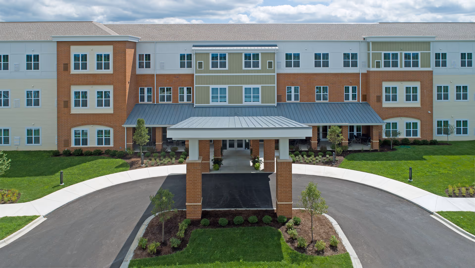 Exterior view of Melody Living Lake in the Hills with circular drive and entrance canopy.